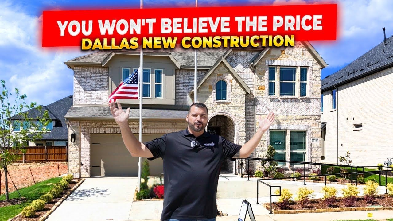 A man is standing in front of a house that is under construction.