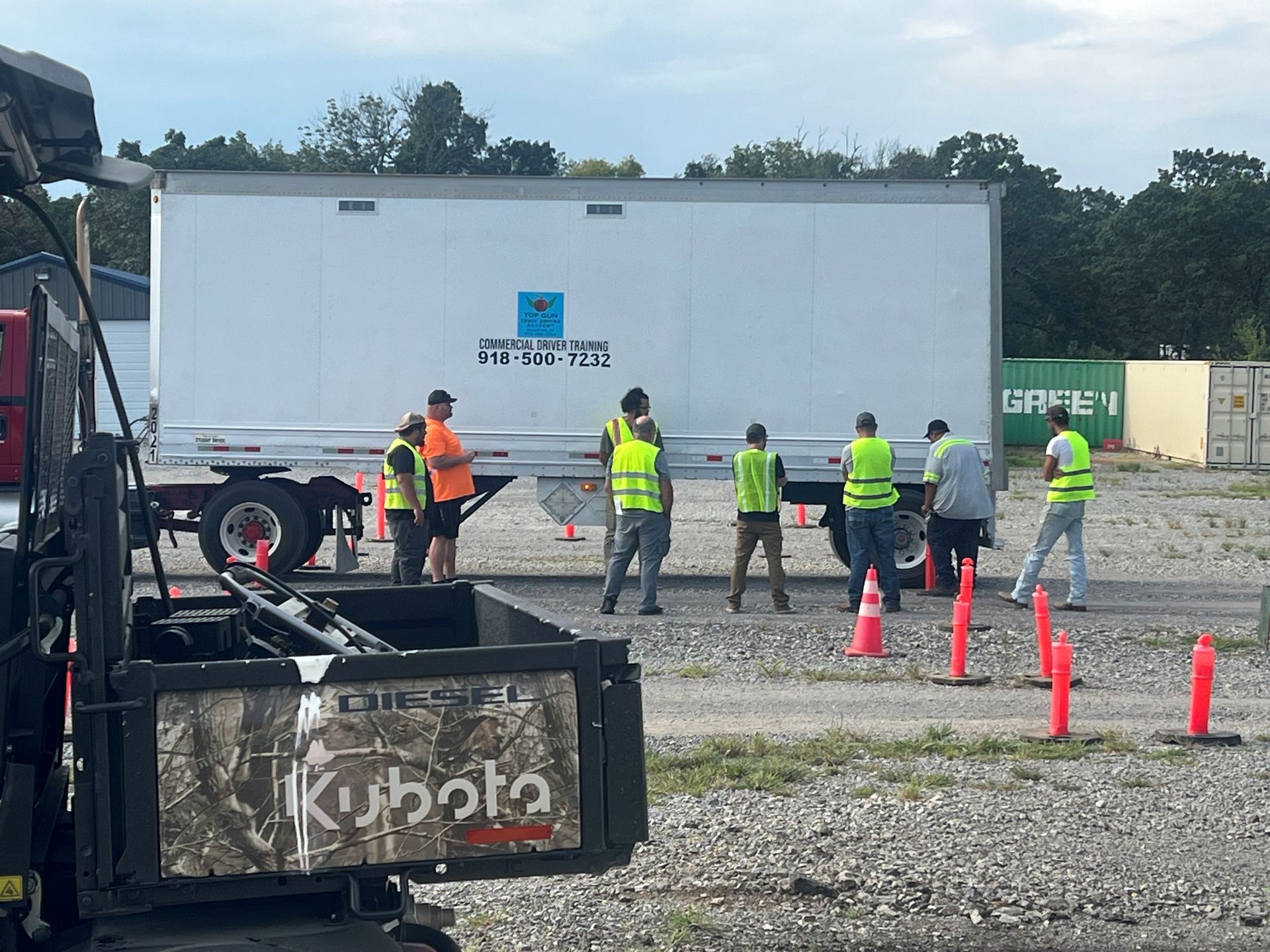 Truck driver in cab looking at paperwork.