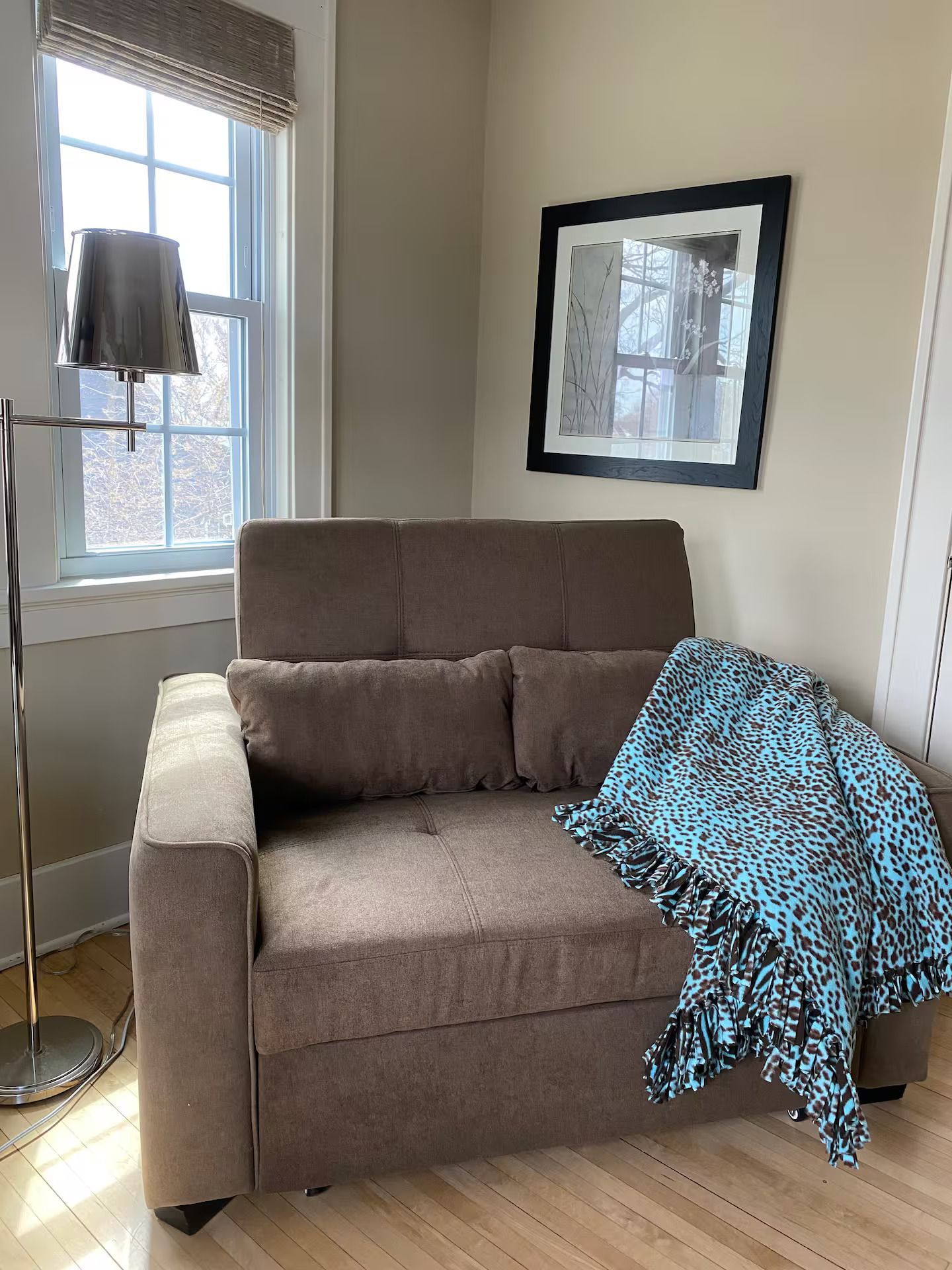 A living room with a chair and a lamp