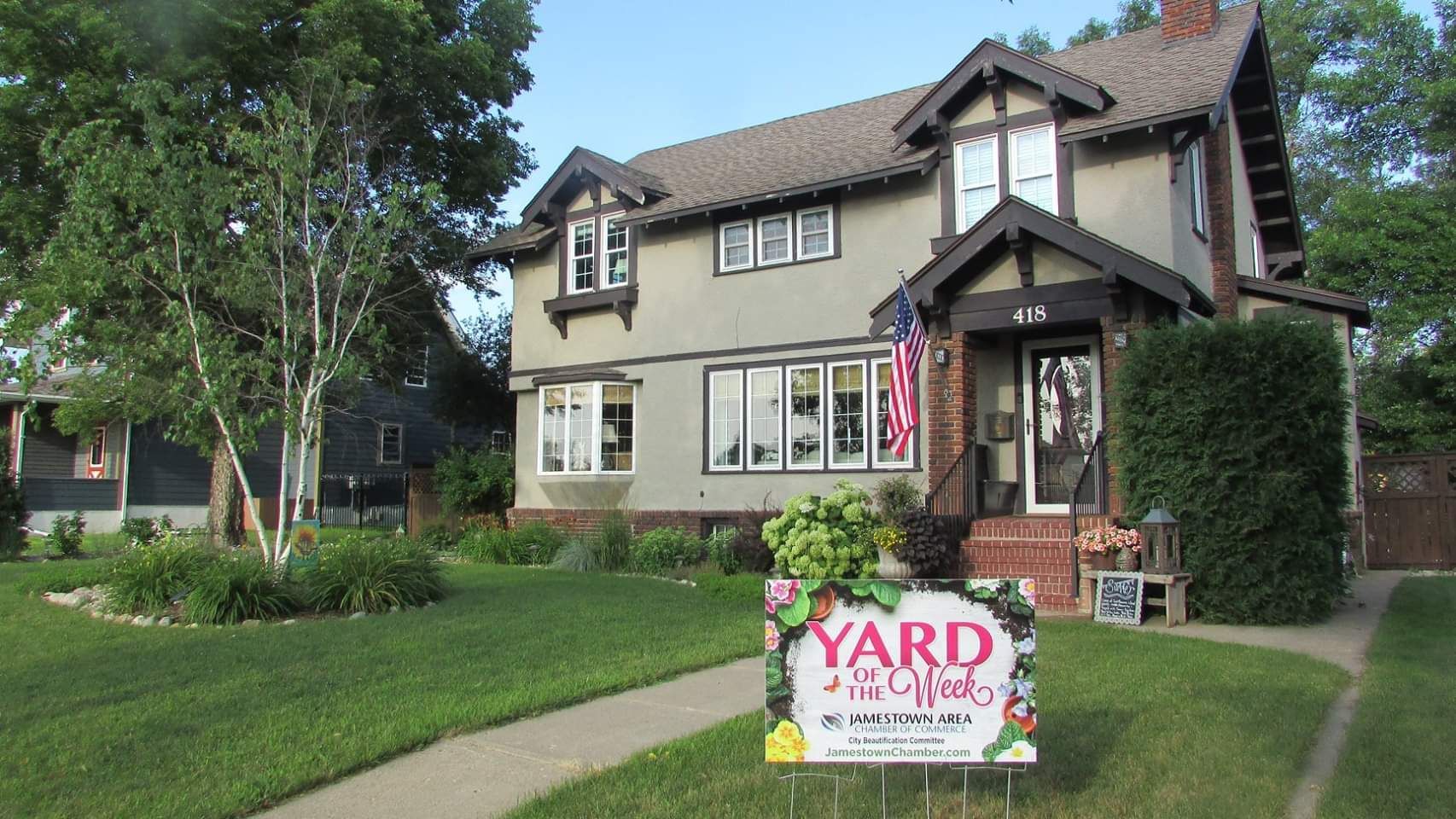 A house with a yard sign in front of it