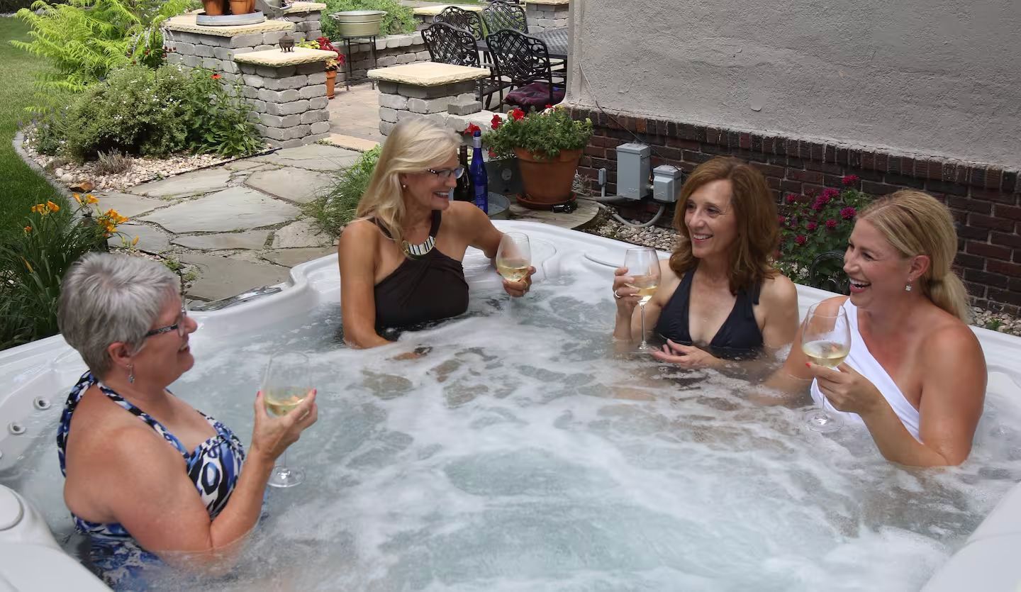 A group of women are sitting in a hot tub