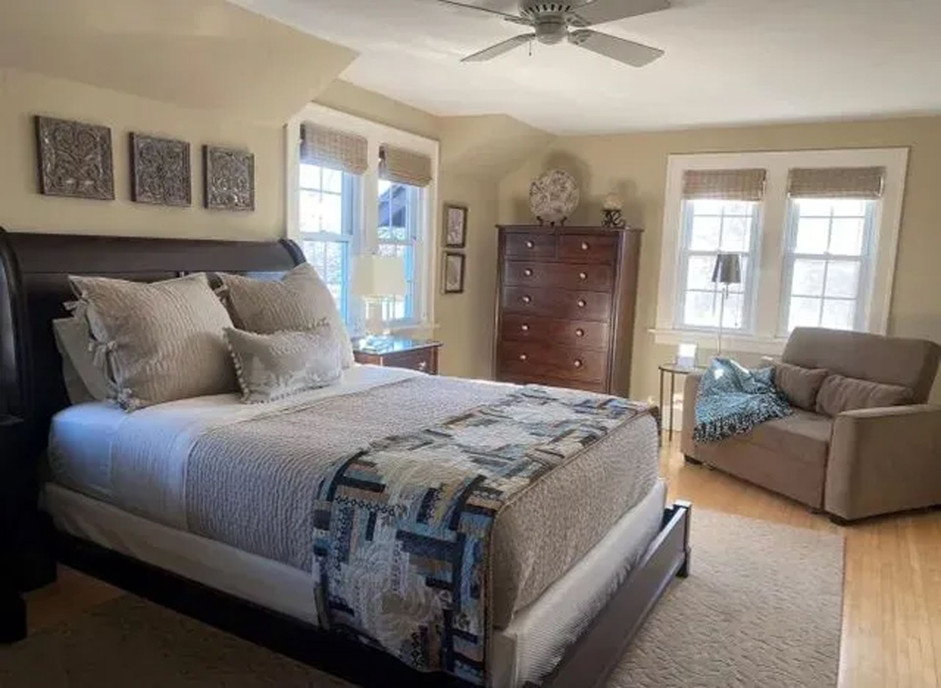 A bedroom with a king size bed and a chair