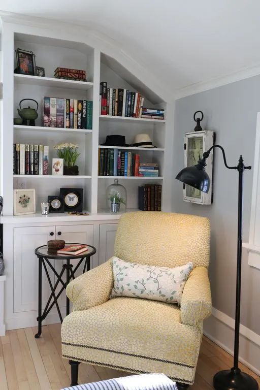 A living room with a yellow chair and a lamp