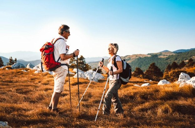 A man and a woman are hiking in the mountains.