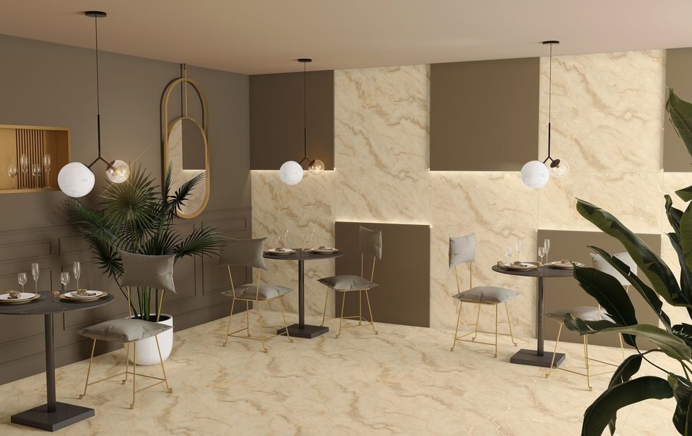 Upscale cafe interior with round tables, globe lights, and beige marble tile.