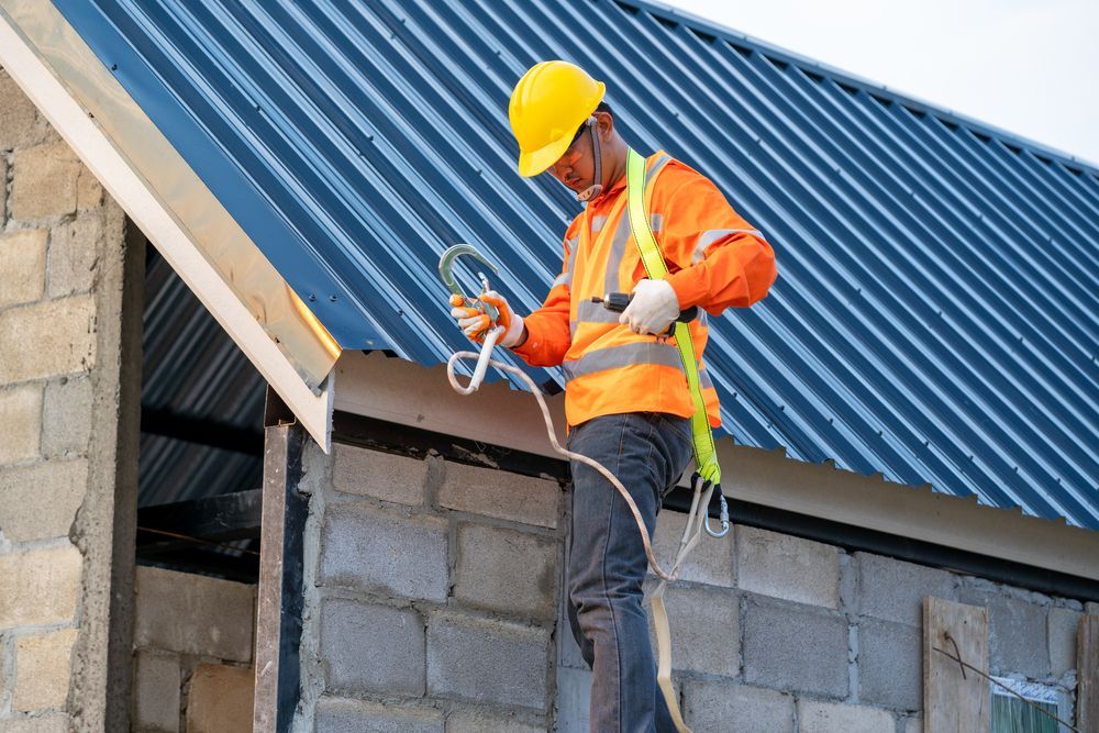 Man on ladder installing cable near an air conditioner unit.