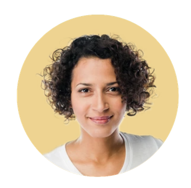 Woman with curly dark hair smiles at the camera, set against a yellow background. She wears a white shirt.