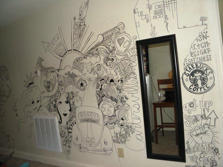 A room with graffiti on the wall and a mirror