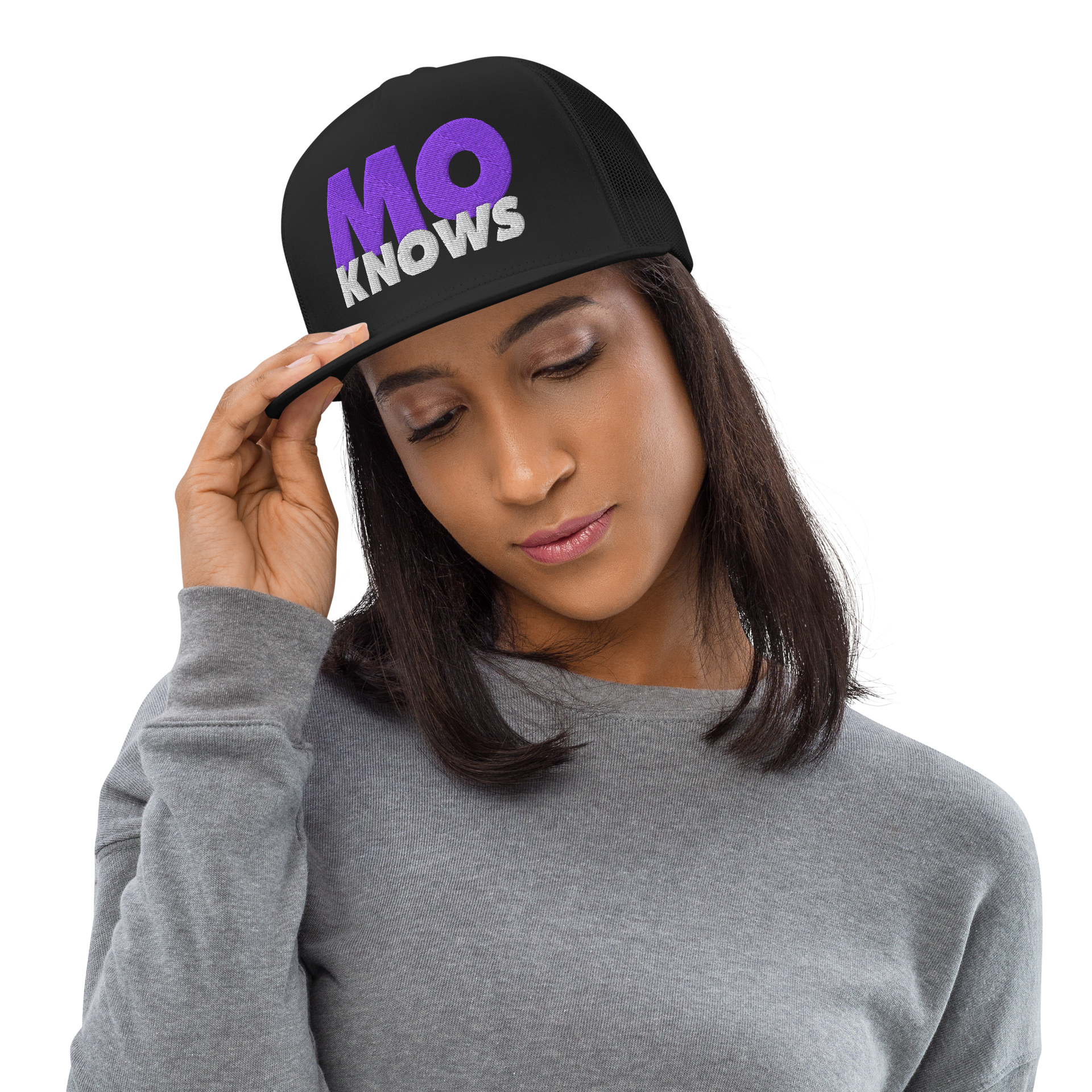 A woman wearing a black hat with the words `` no knows '' on it.