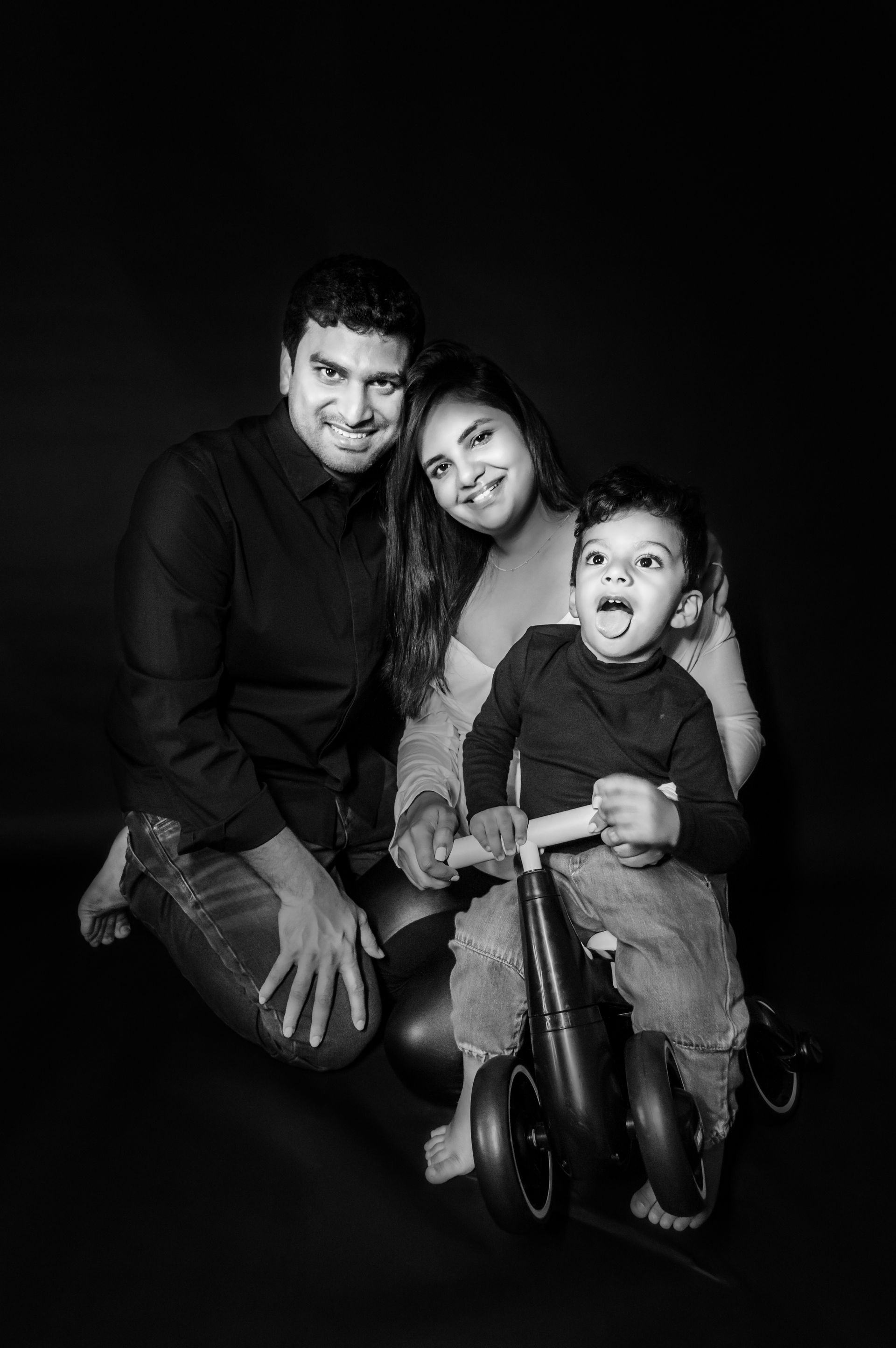 A black and white photo of a family posing for a picture.