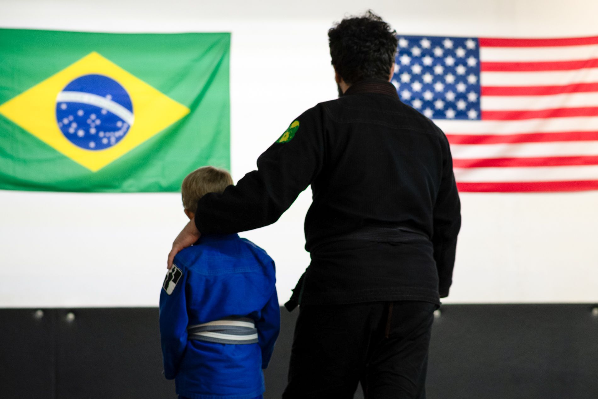 A computer monitor a laptop and a tablet are on a wooden table.