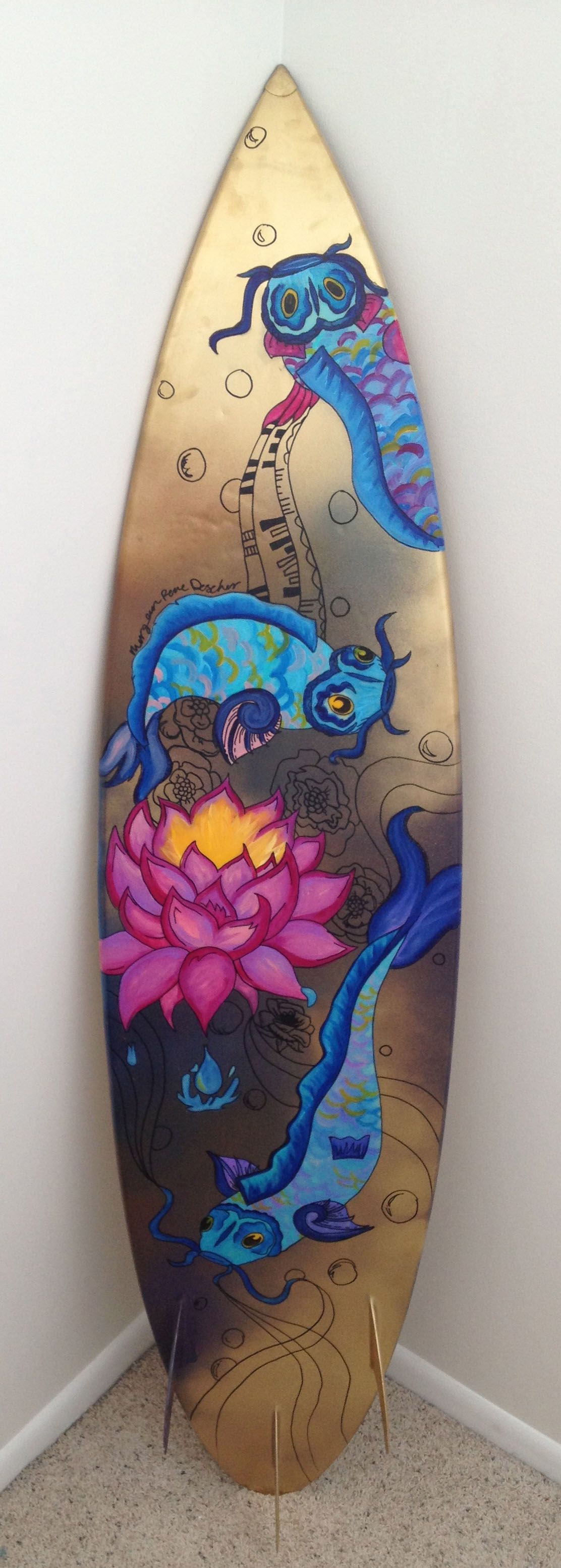 A surfboard with a dragon on it is sitting in a corner of a room.