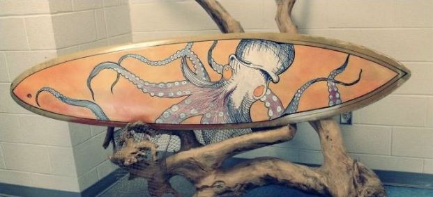 A surfboard with an octopus painted on it