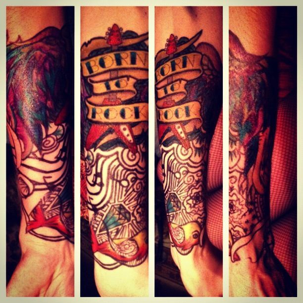 A tattoo on a person 's arm that says born to rock