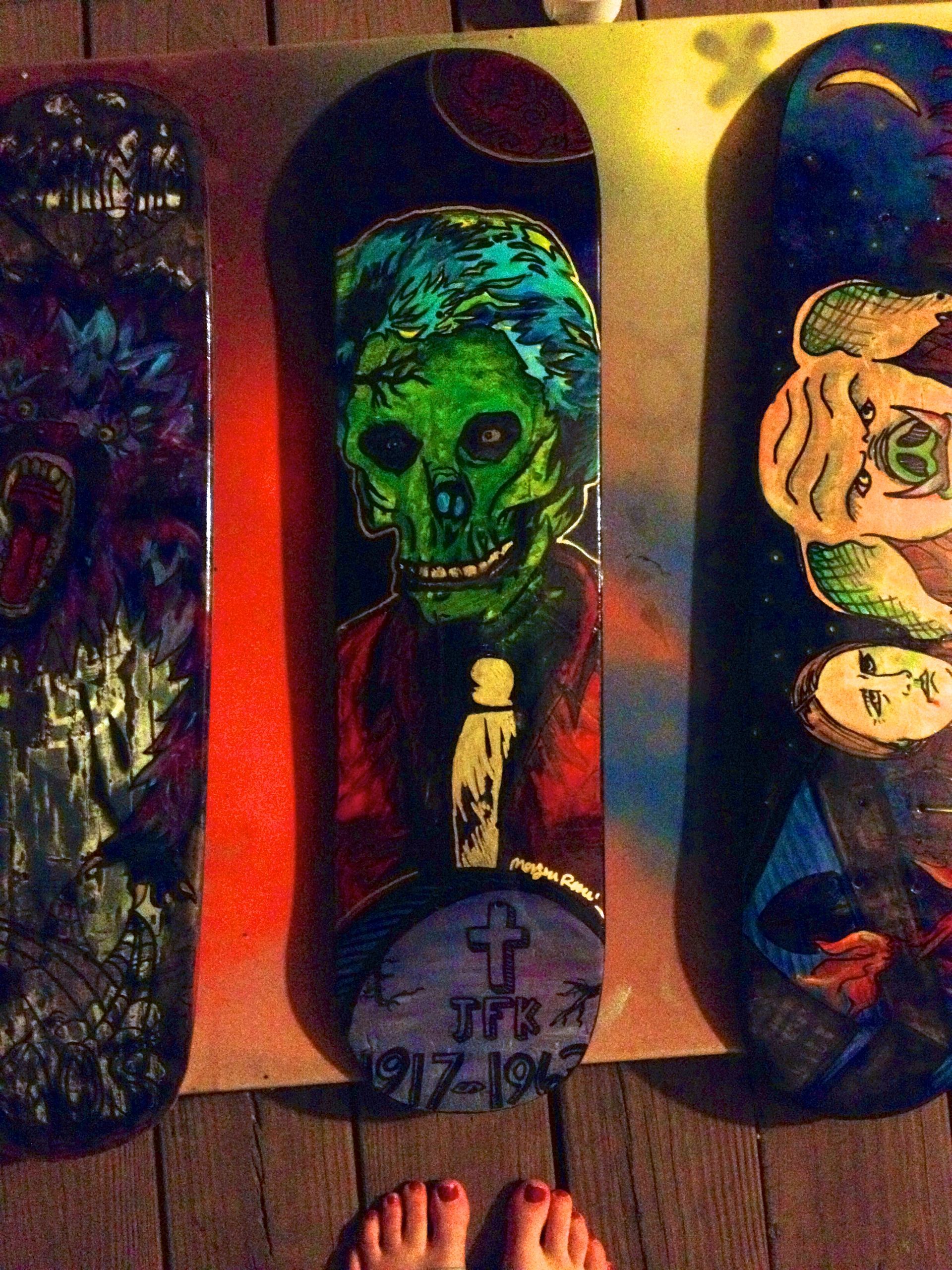A painting of a skull is on a skateboard