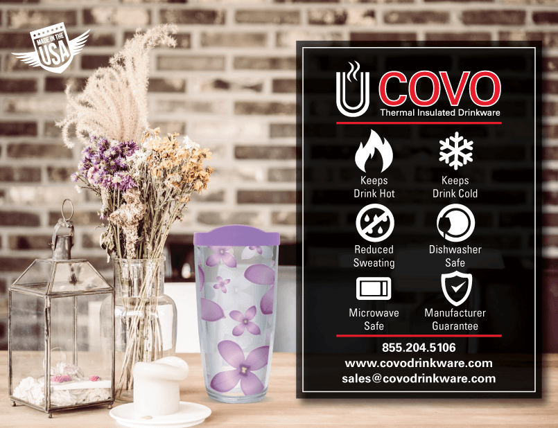 A purple tumbler is sitting on a wooden table next to a vase of flowers designed by Morgan René Doscher