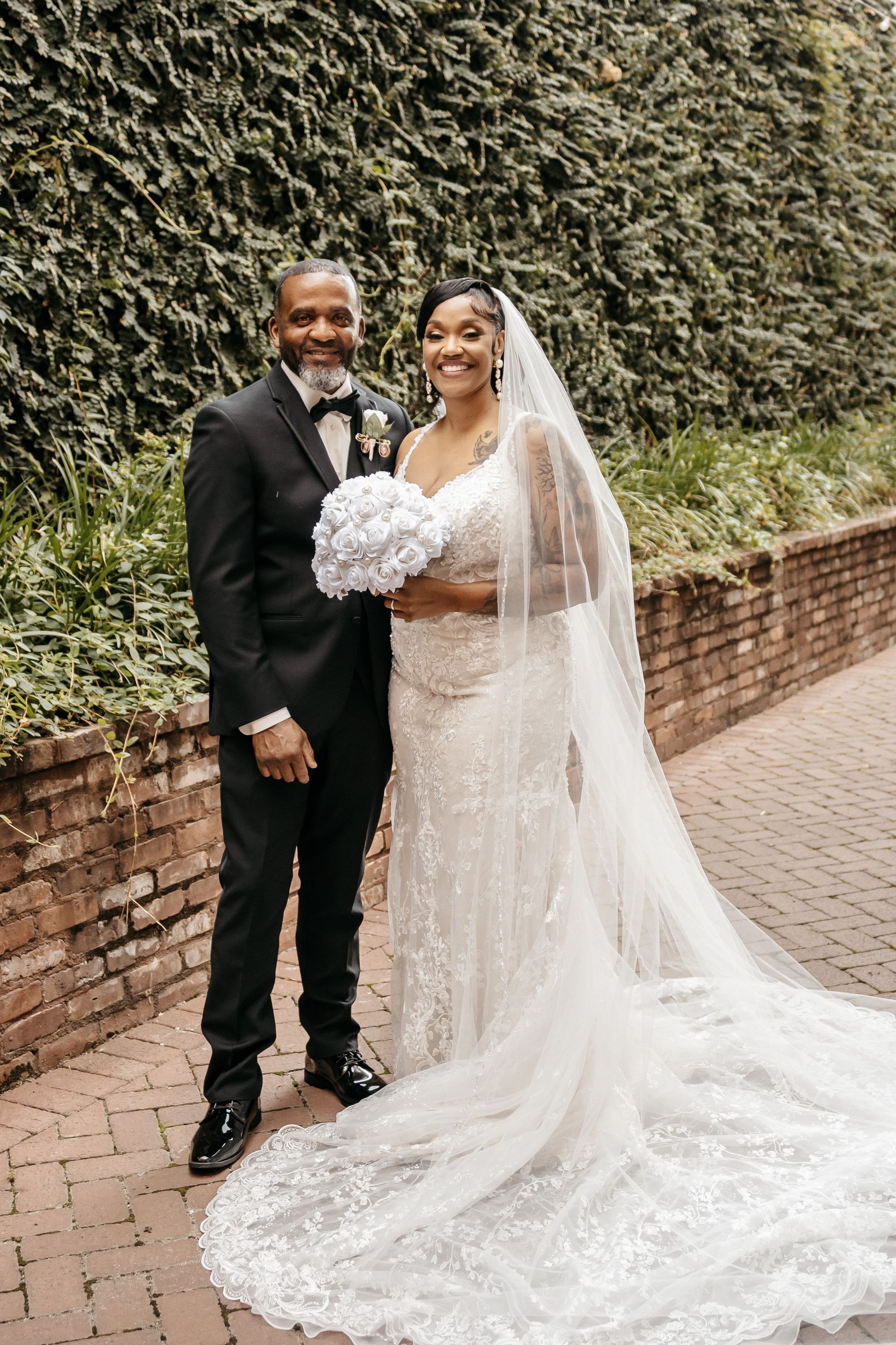 A bride and groom are posing for a picture on their wedding day.