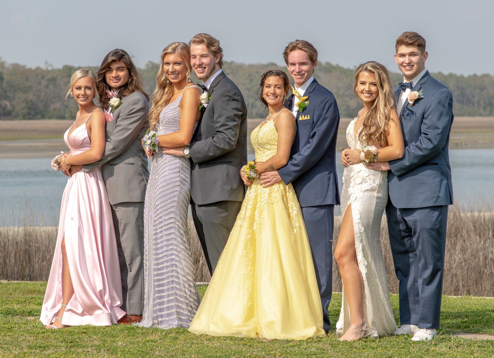 Prom picture of young couples in dresses and suits on the waterway in North Myrtle Beach taken by Morgan Doscher