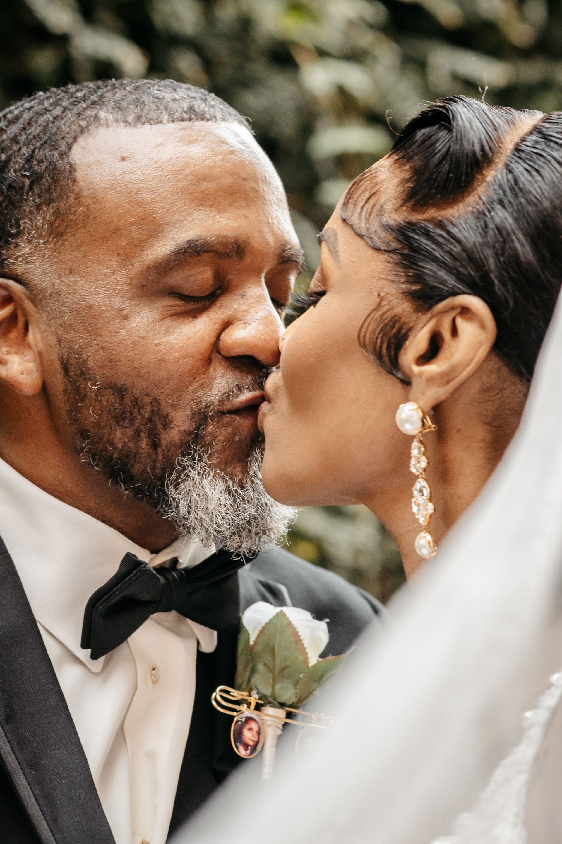 A man and woman are kissing on their wedding day.