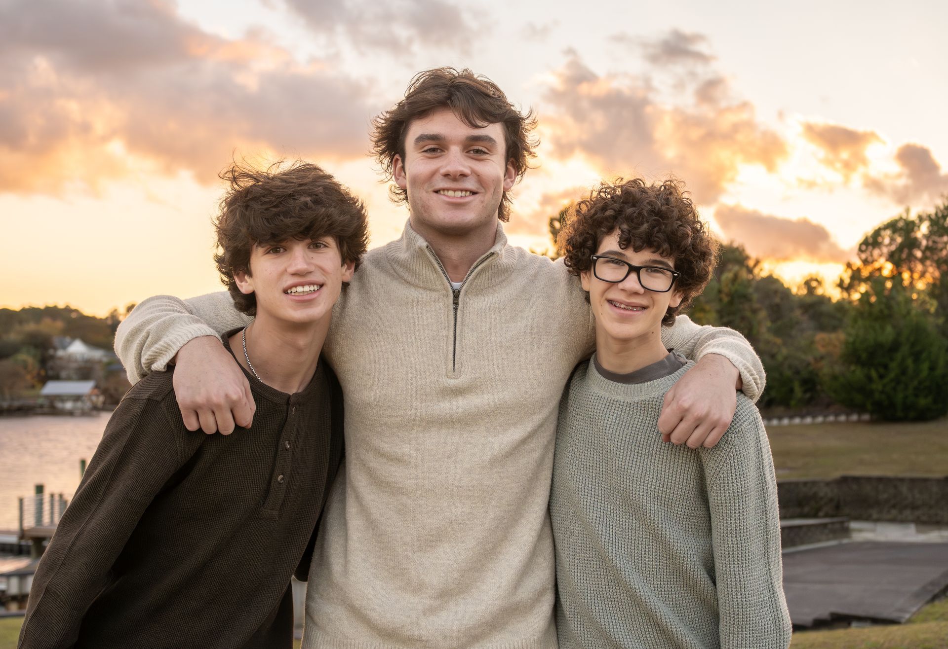 Three young men are posing for a picture together.