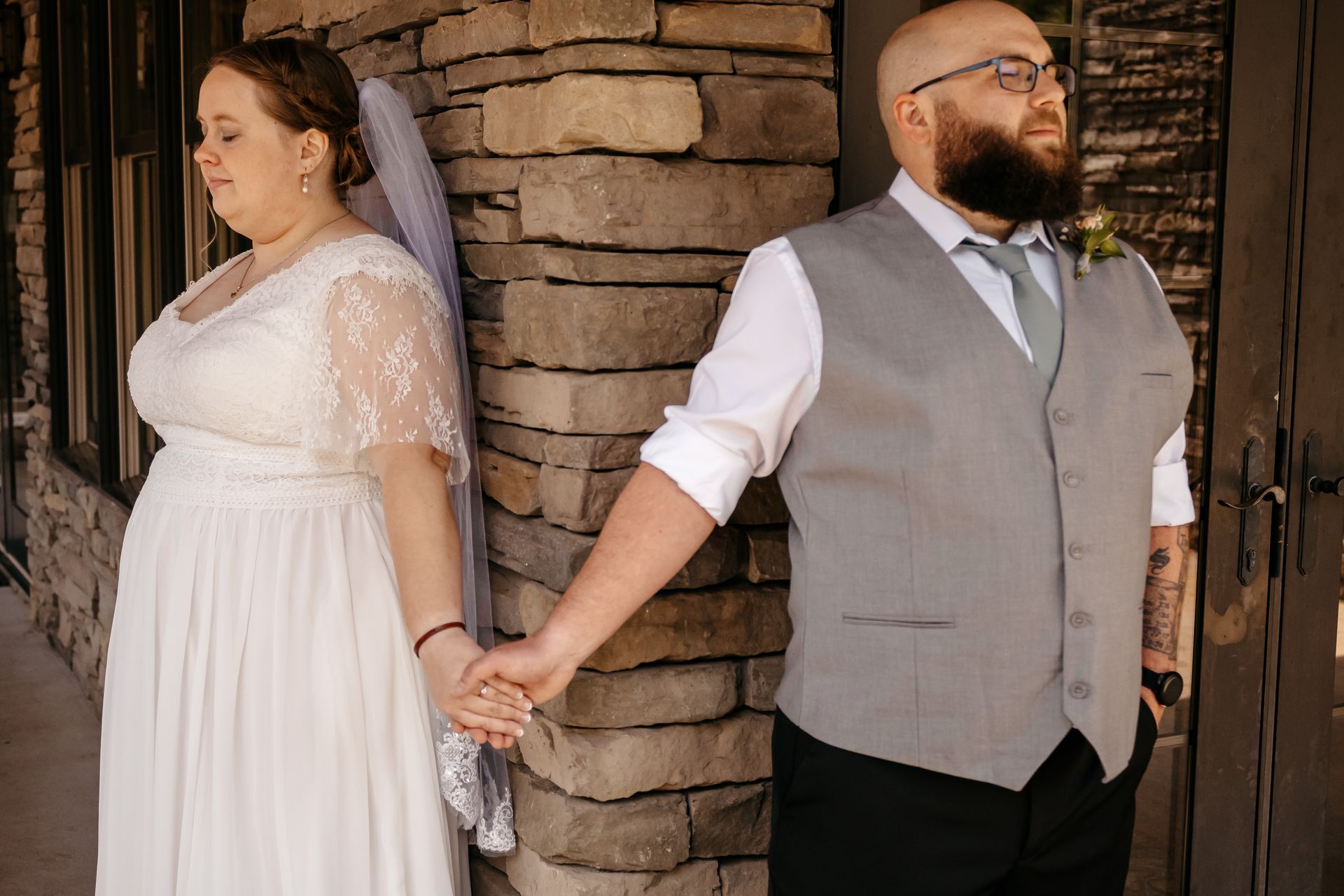 A bride and groom are posing for a picture under a tree.
