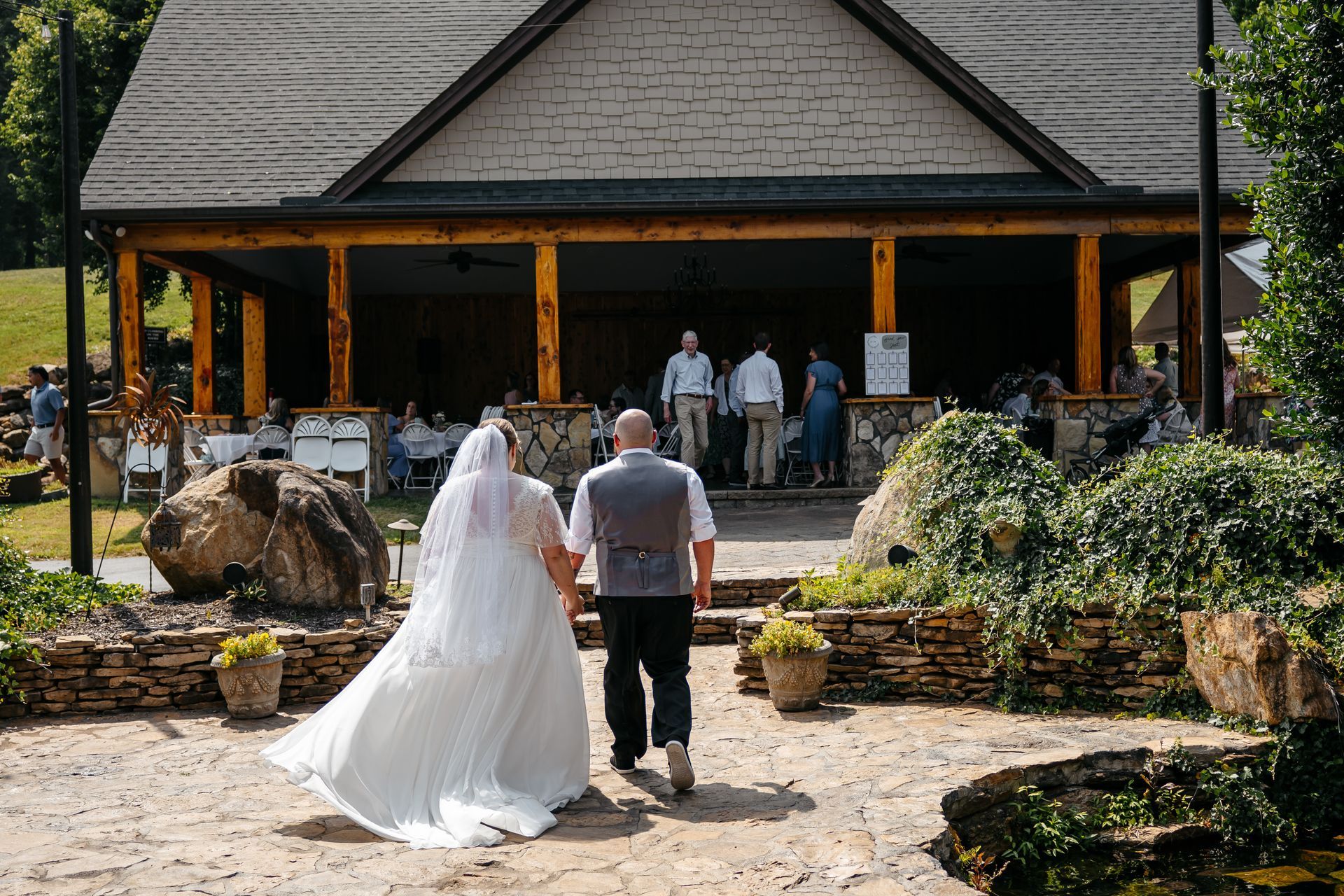 A bride and groom are walking down the aisle at their wedding holding hands.