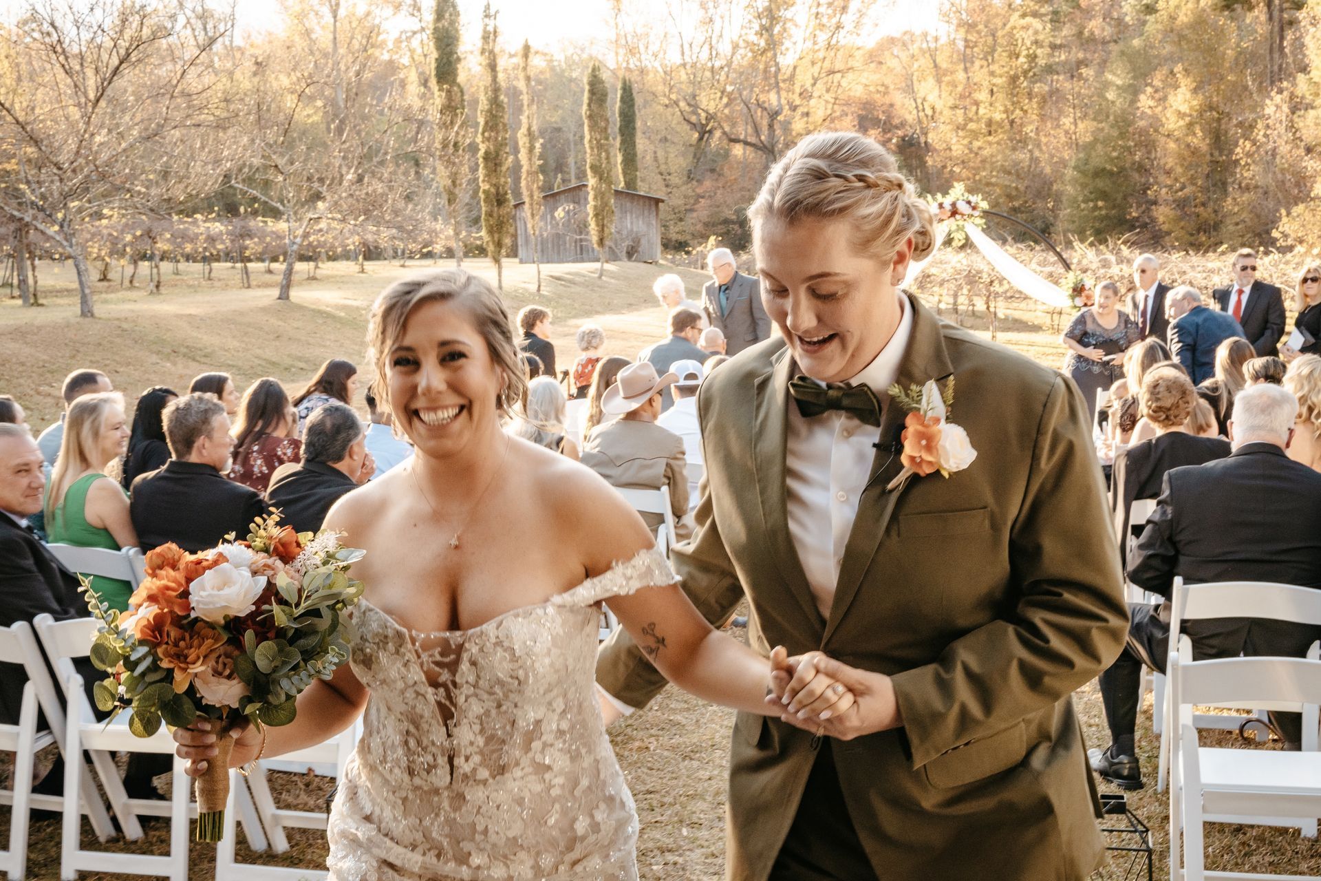 A bride and groom are walking down the aisle at their wedding.