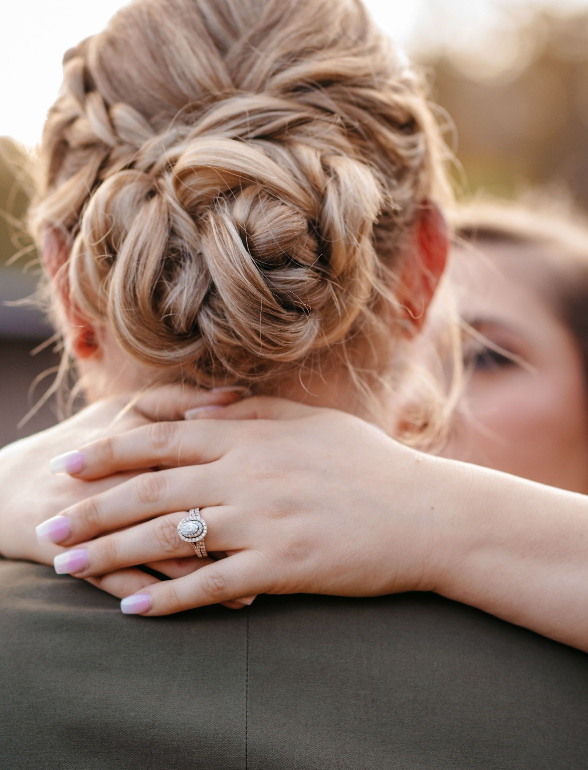 A man and woman are standing under a gazebo in a park.