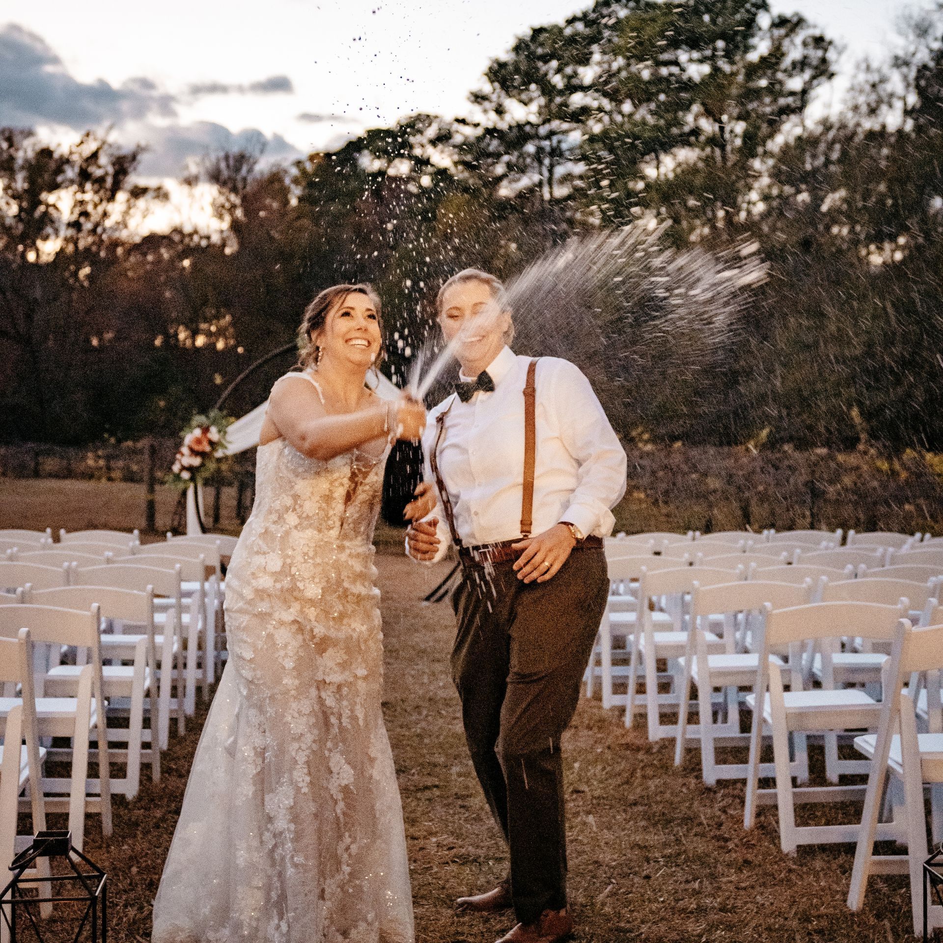 A bride and groom are celebrating their wedding with champagne.