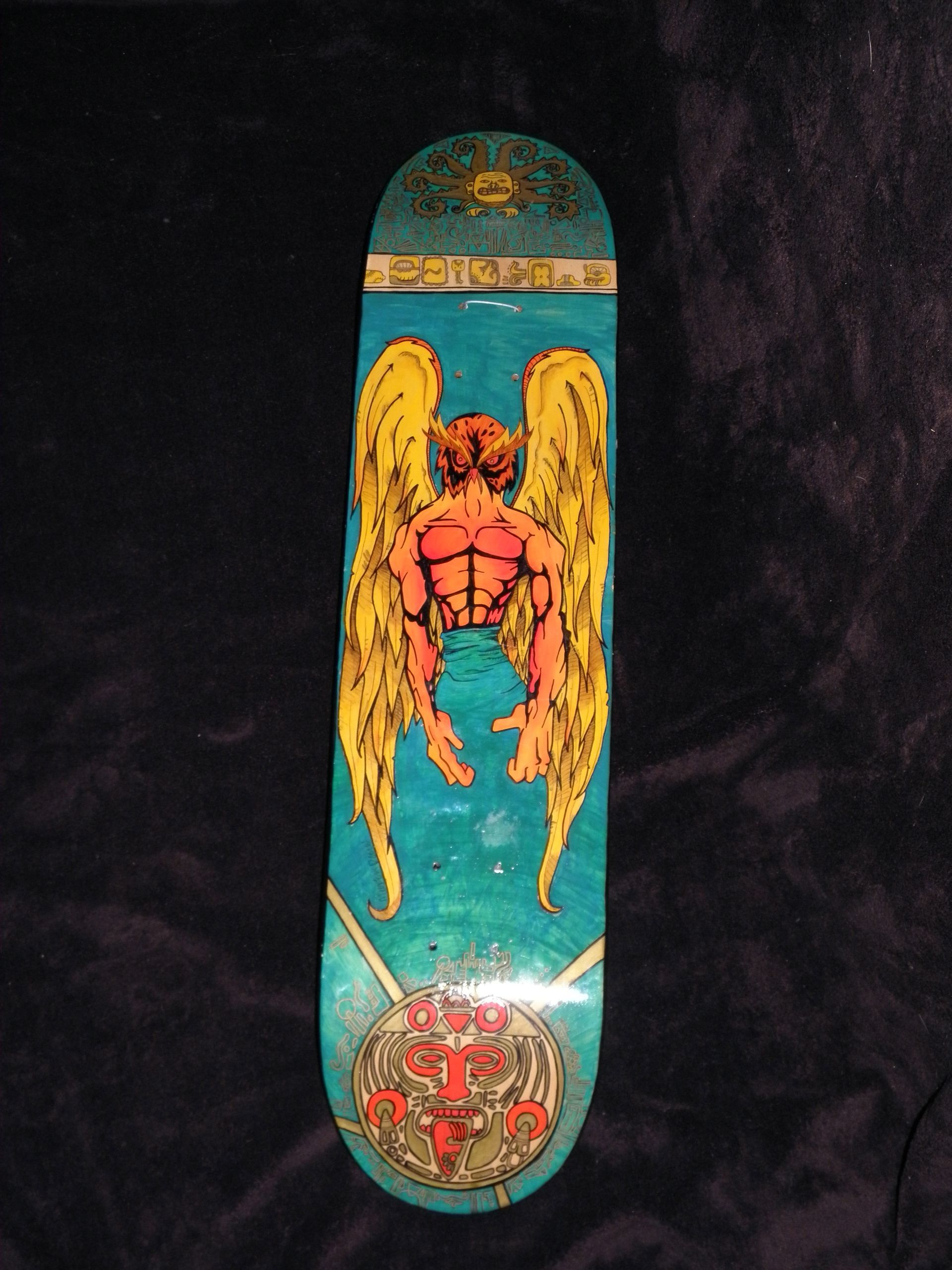 A skateboard with a picture of an angel on it