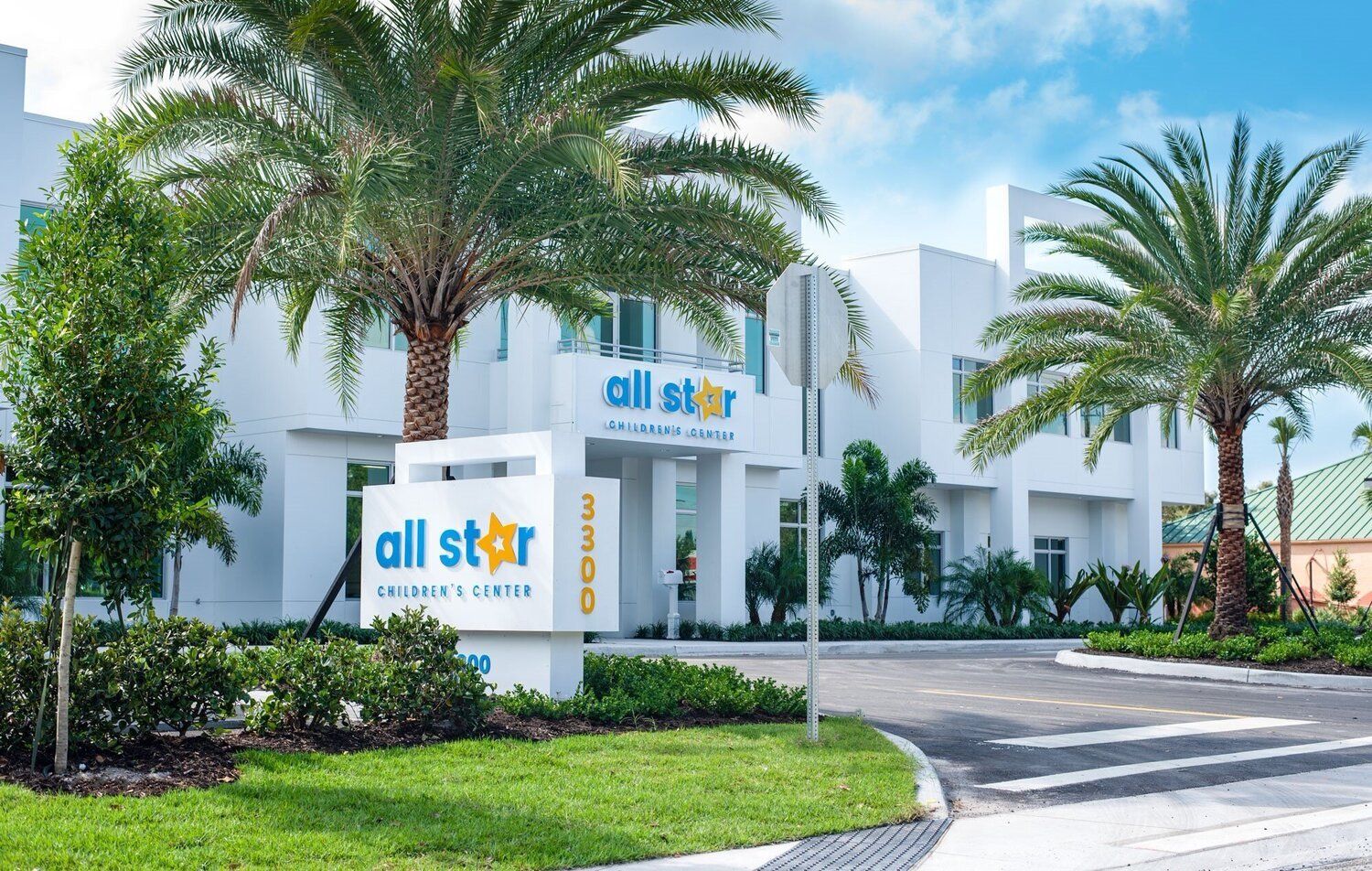 A white building with a sign that says all star