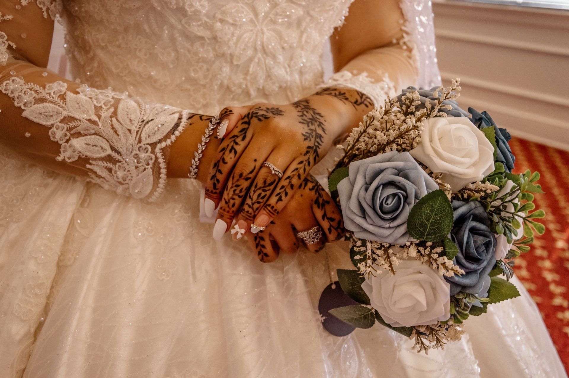 A bride in a wedding dress is holding a bouquet of flowers.