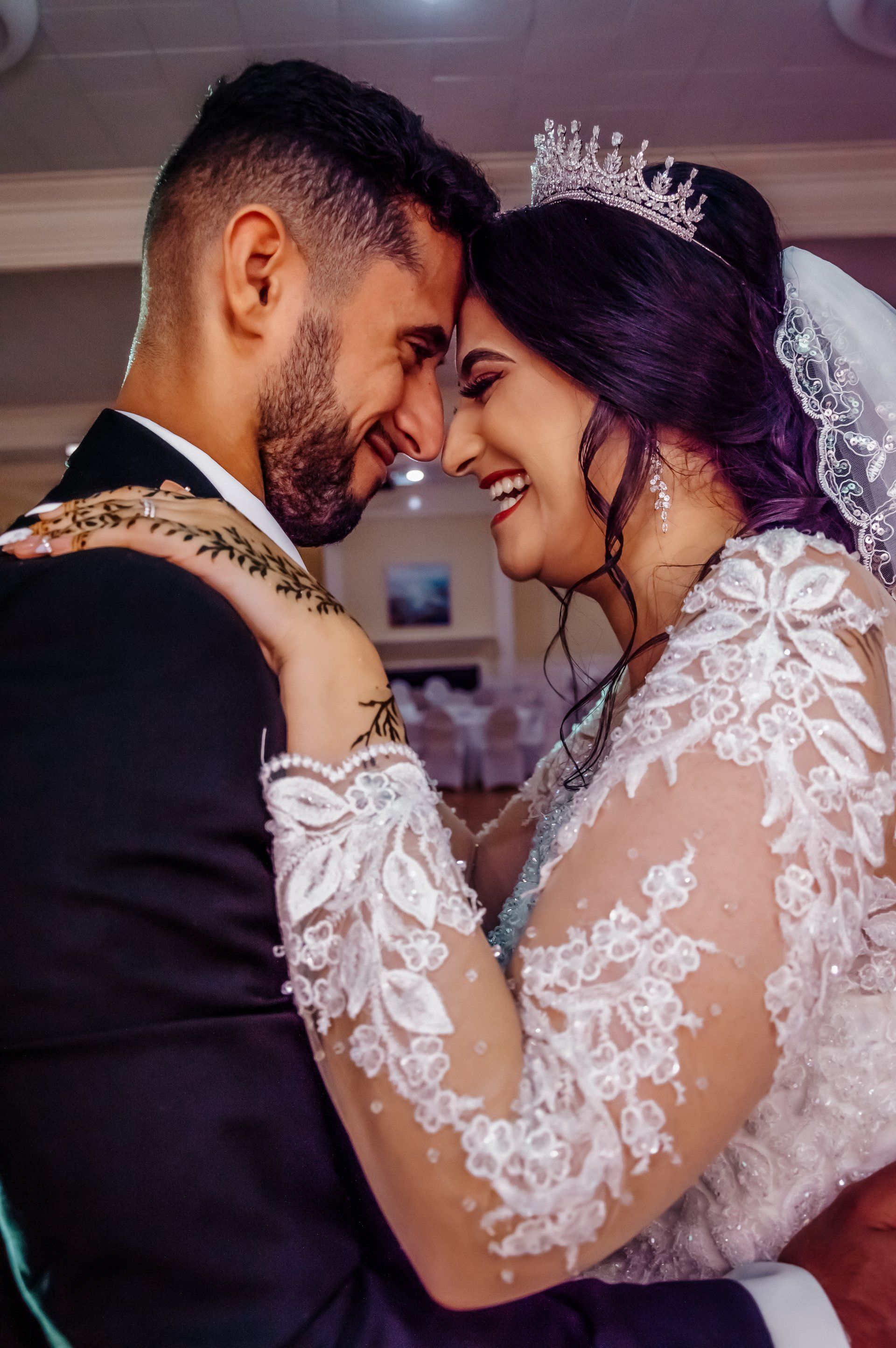 A bride and groom are looking into each other 's eyes on their wedding day.