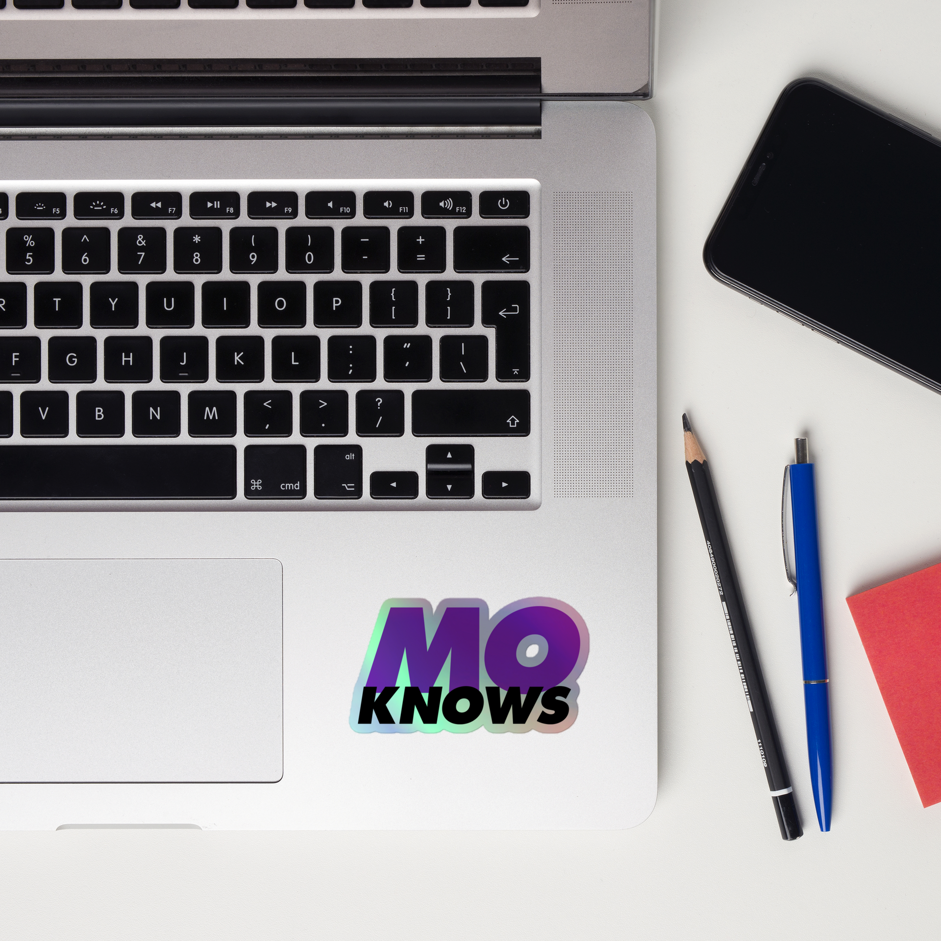 A laptop with a mo knows sticker on it