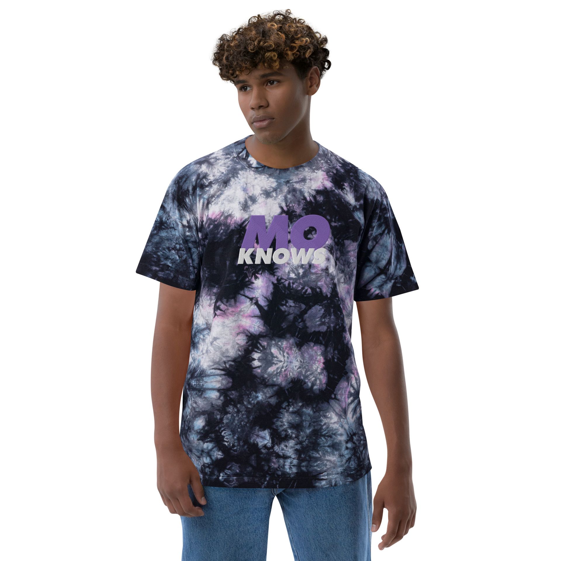 A man wearing a tie dye t-shirt that says me knows