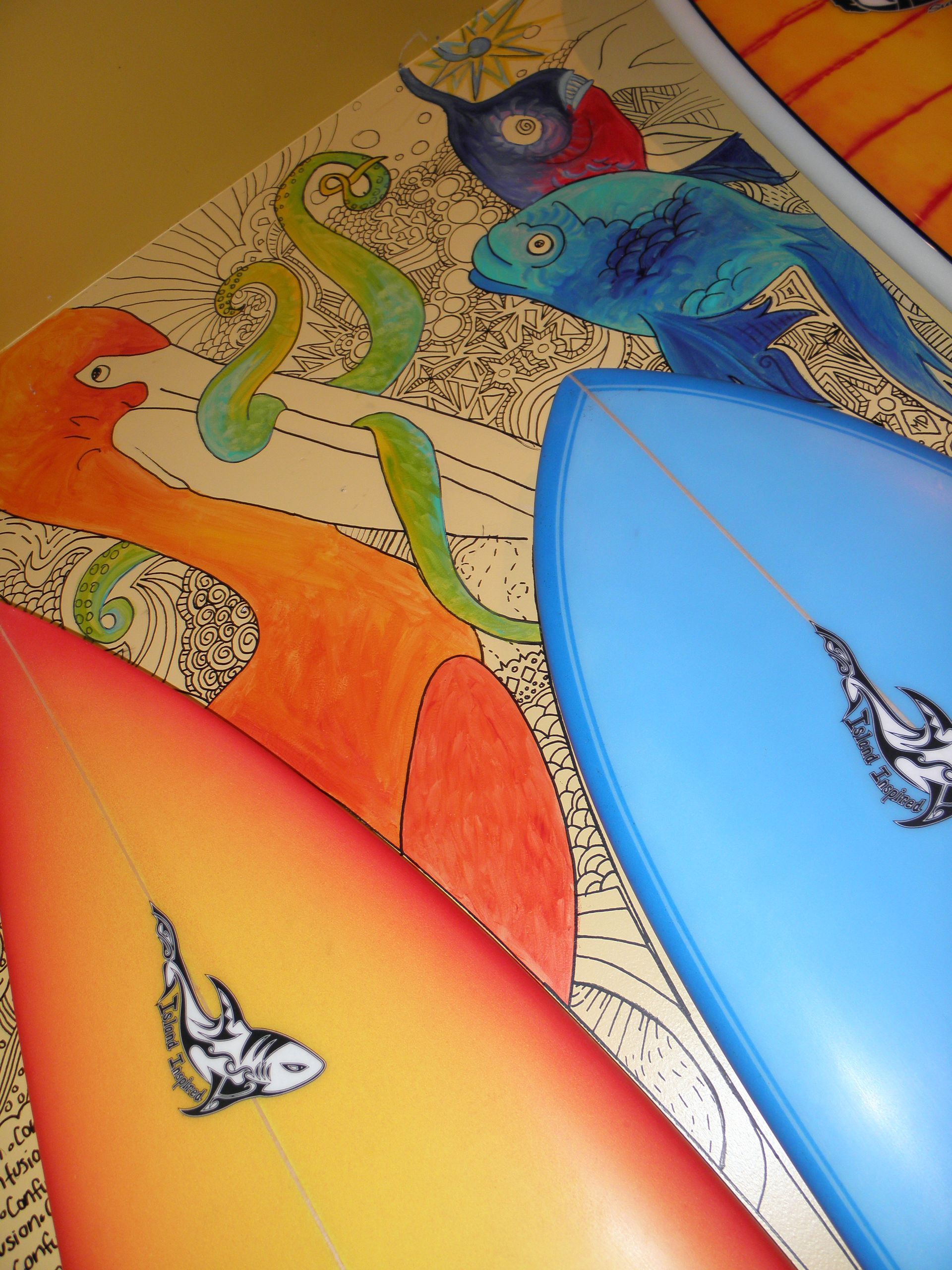 A blue surfboard with a shark on it