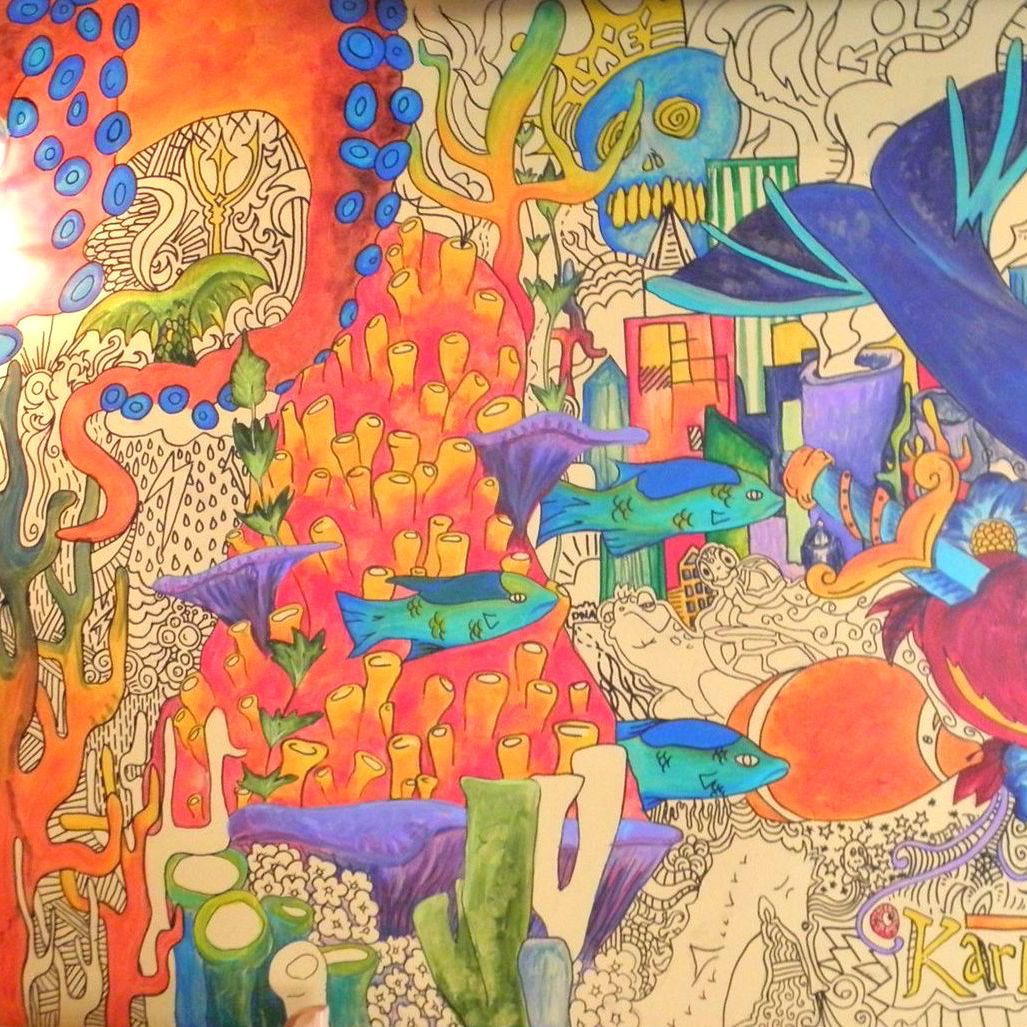 A painting of a coral reef with a skull in the middle