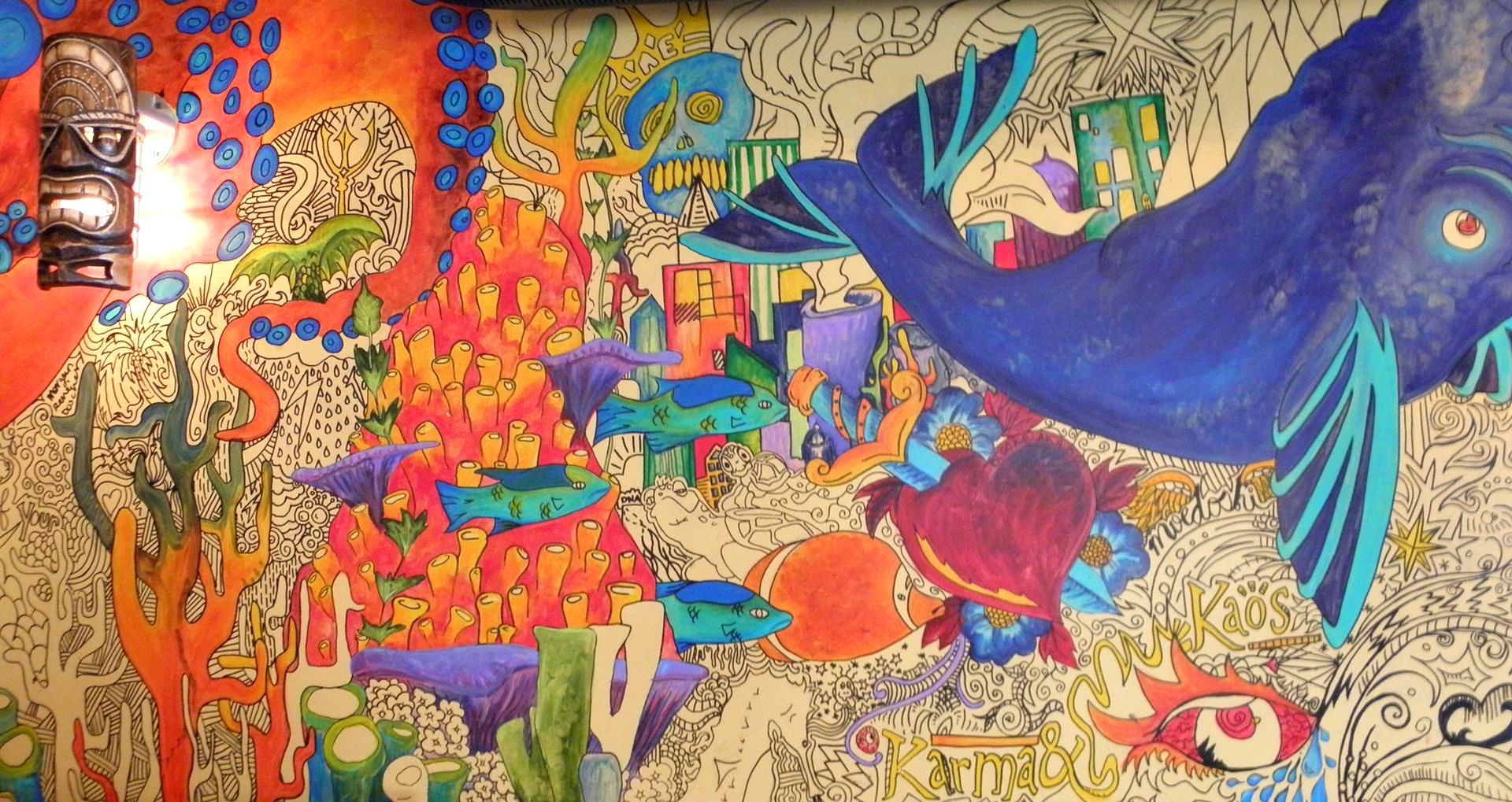 A colorful painting with a blue whale on it