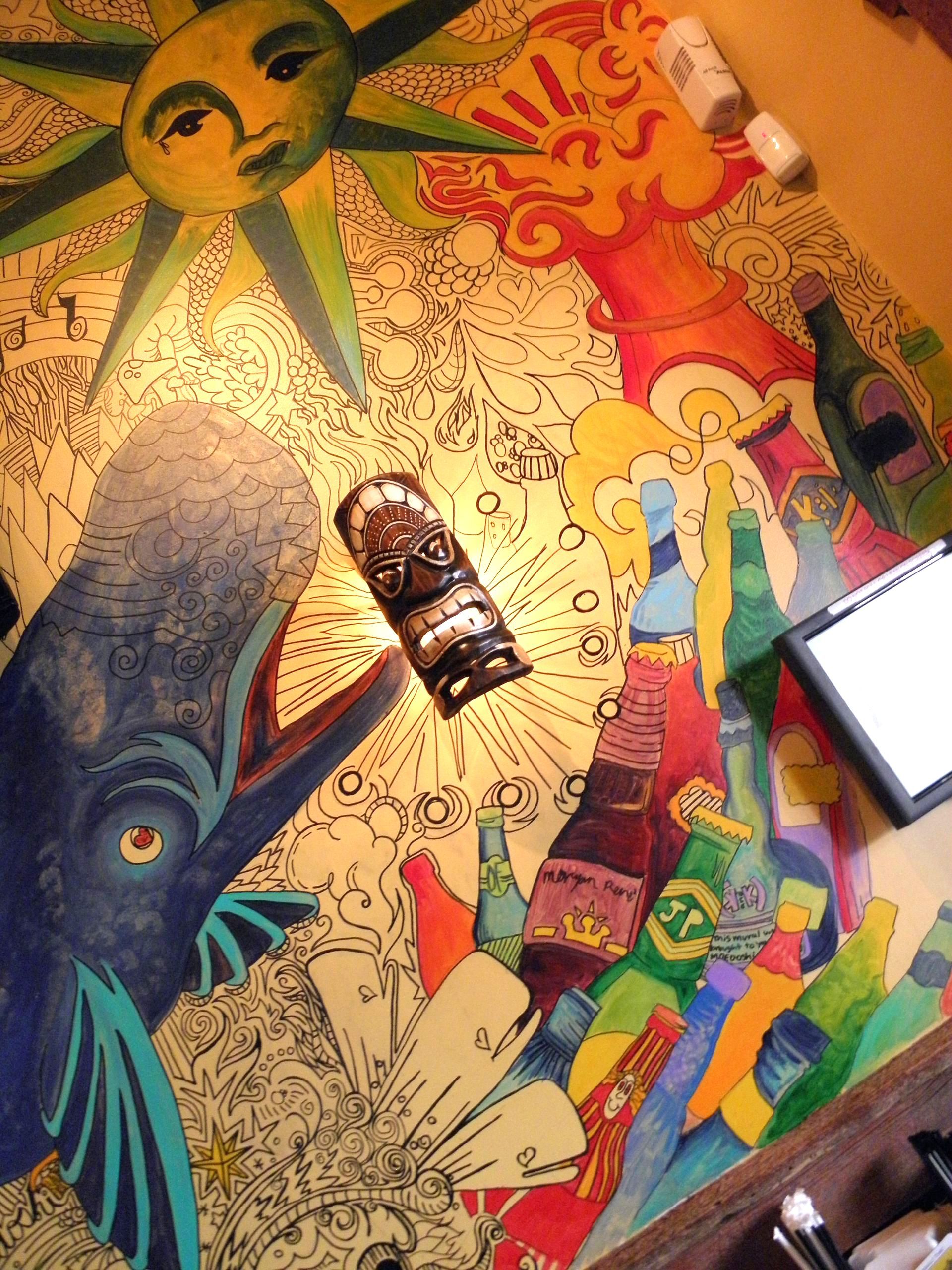 A painting of a whale and a sun is on a table