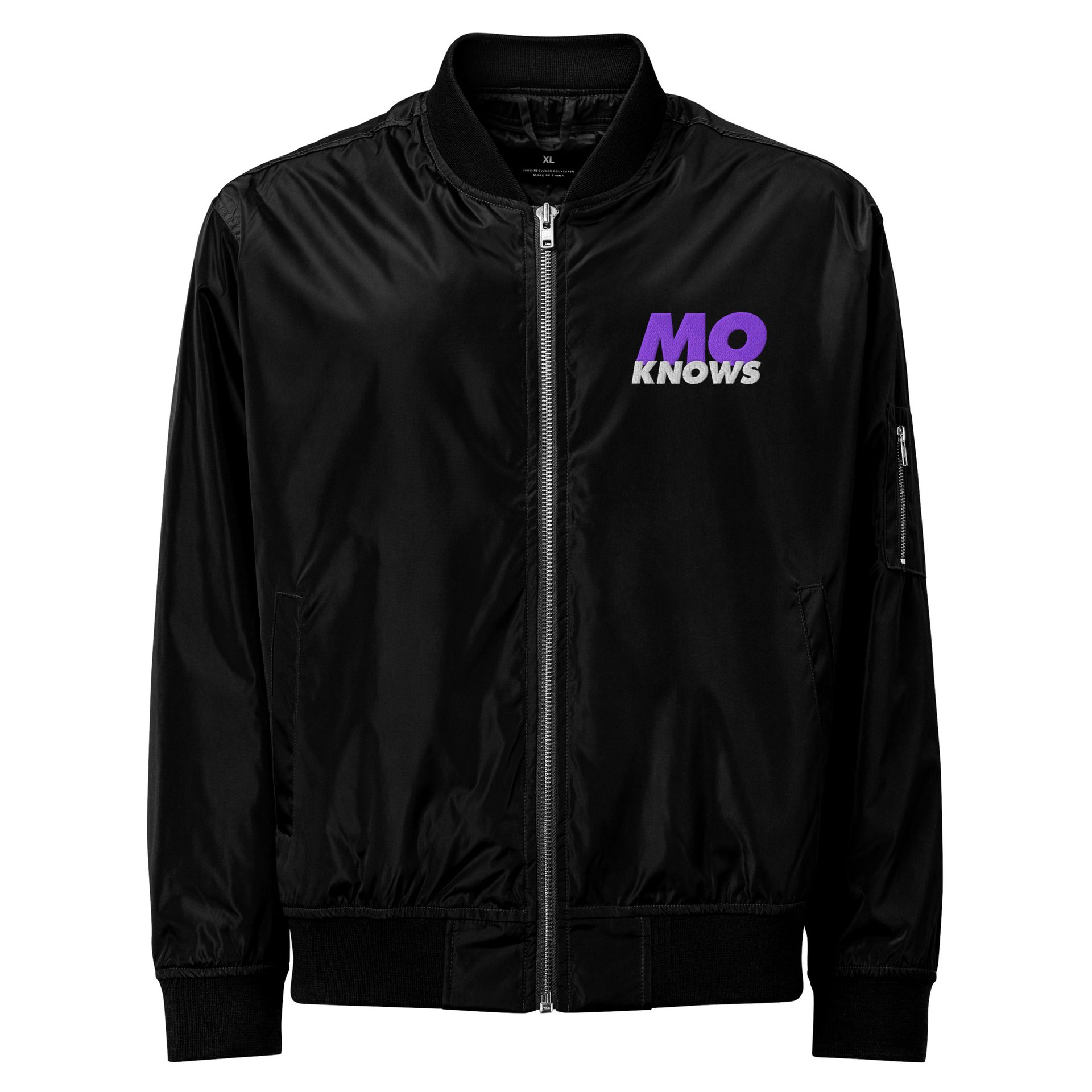 A black bomber jacket with a purple mo knows logo on the front
