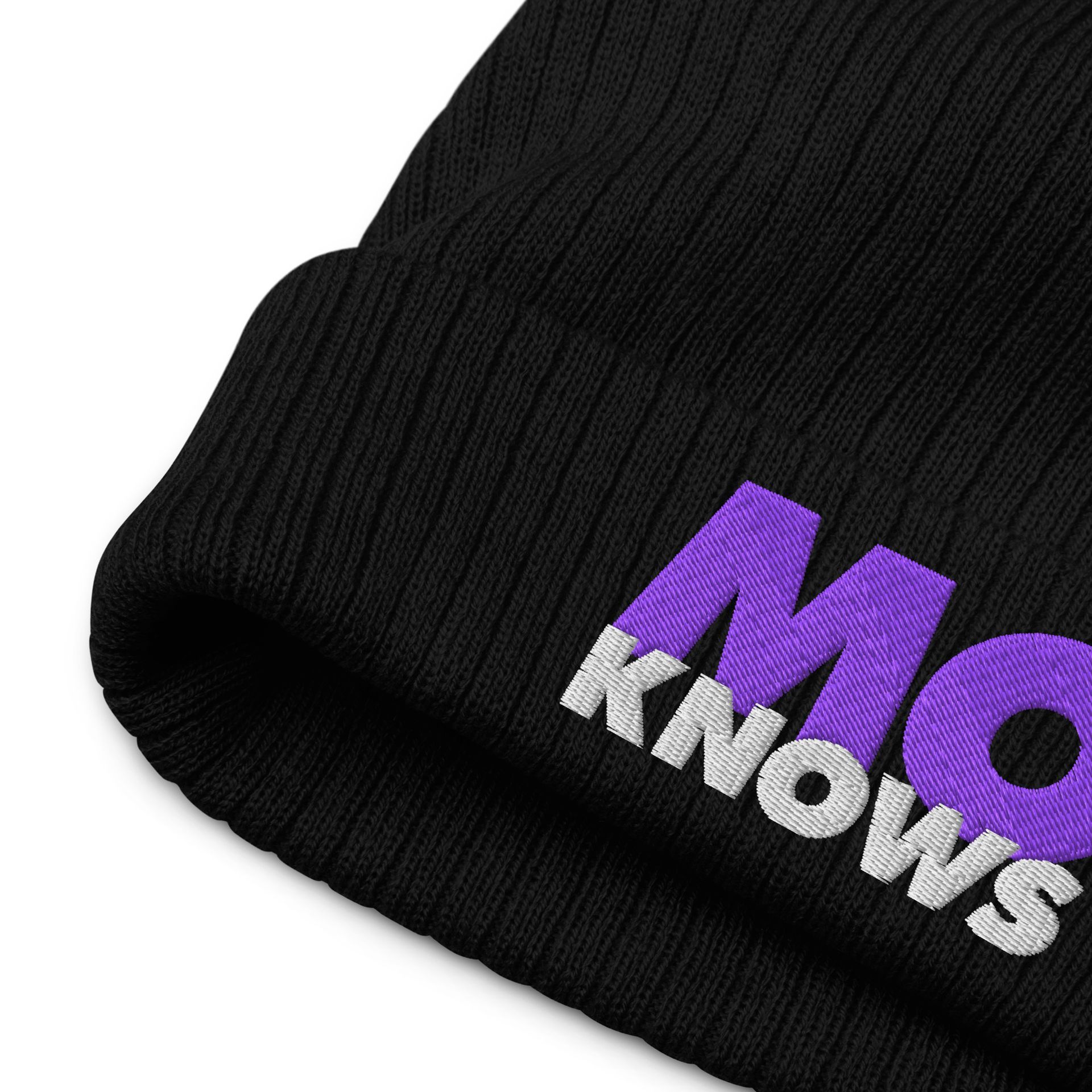 A close up of a black beanie with the word mo knows embroidered on it