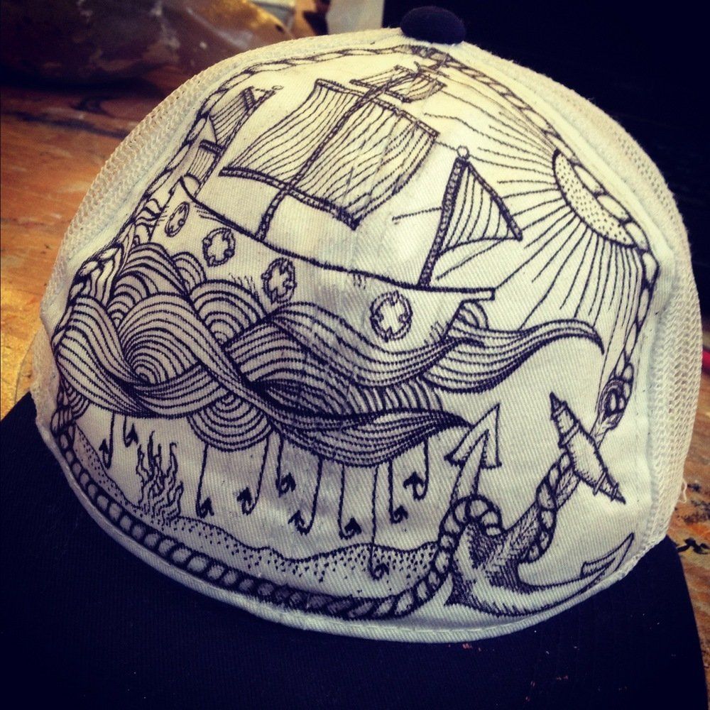 A hat with a drawing of a ship on it