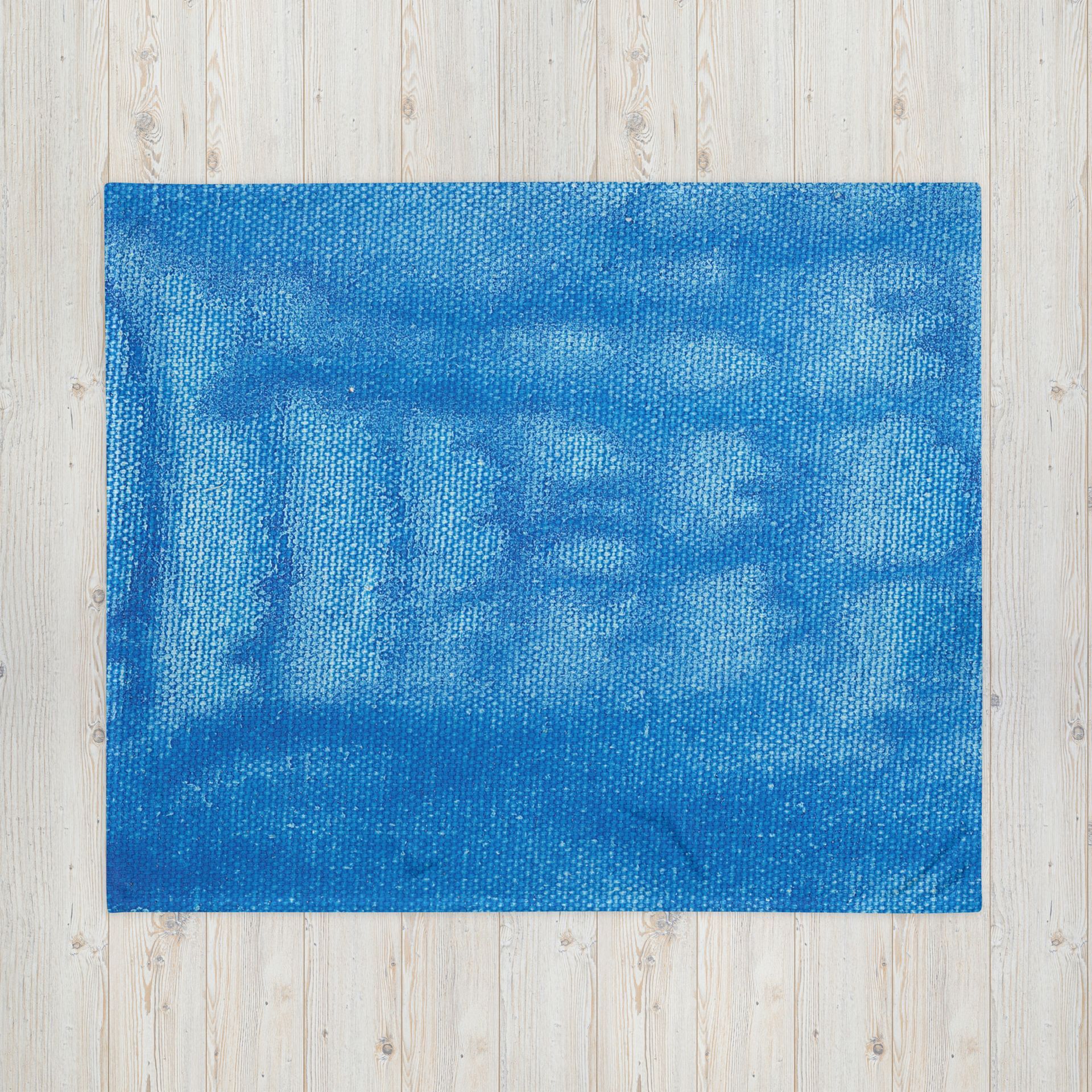 A blue rug is sitting on top of a wooden table.