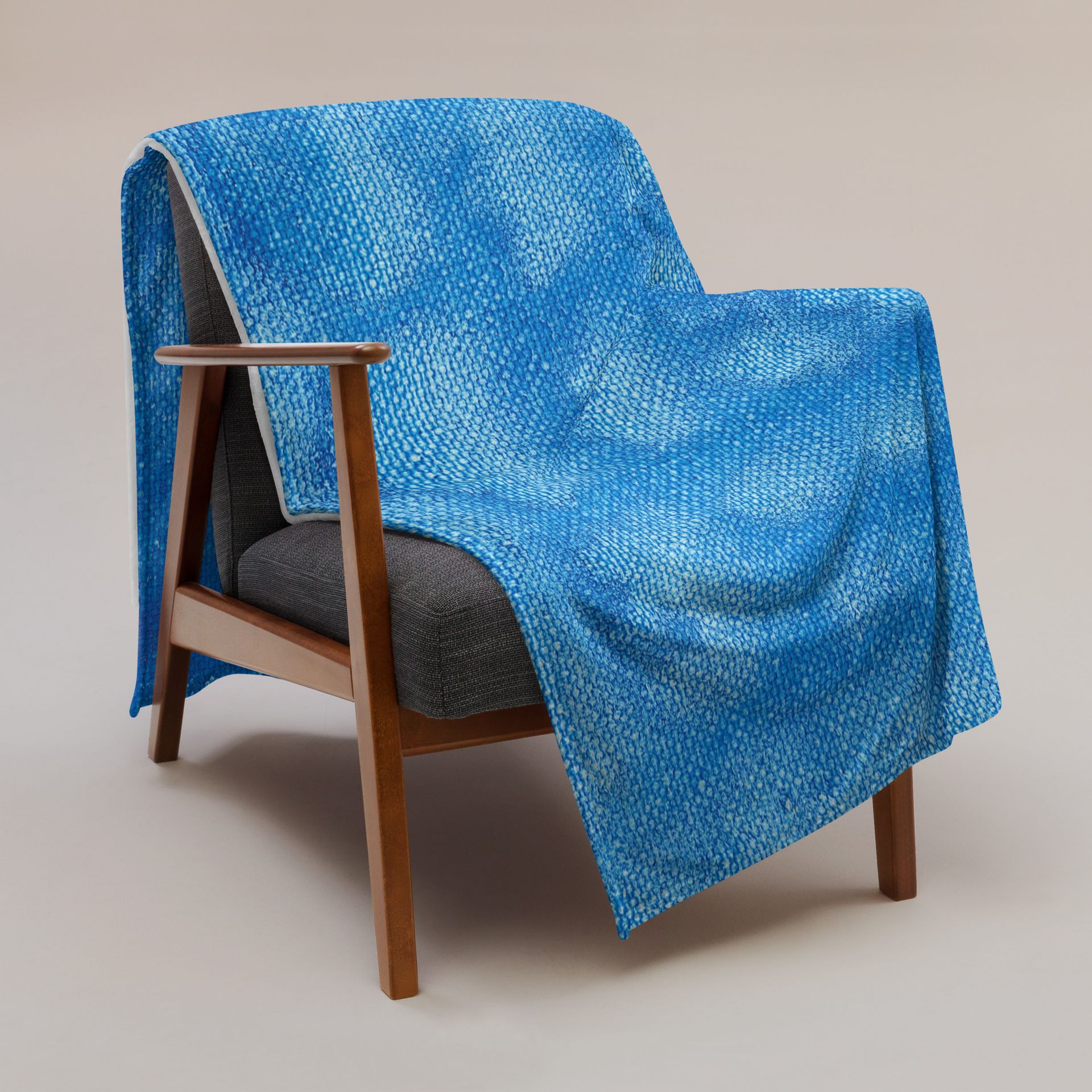 A chair with a blue blanket on it