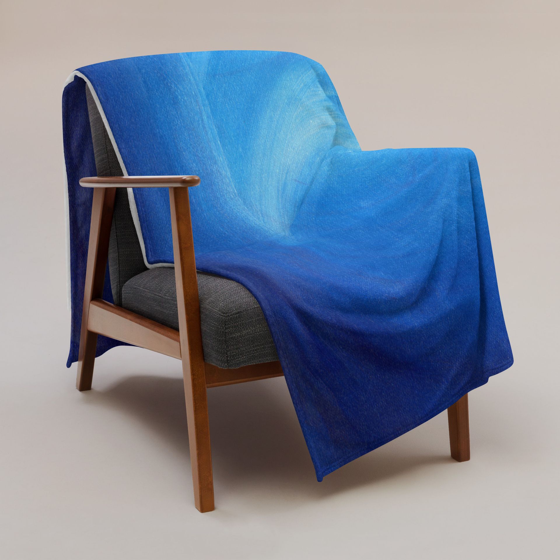 A chair with a blue blanket on it