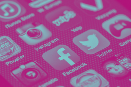 A close up of a cell phone screen with social media icons on it.