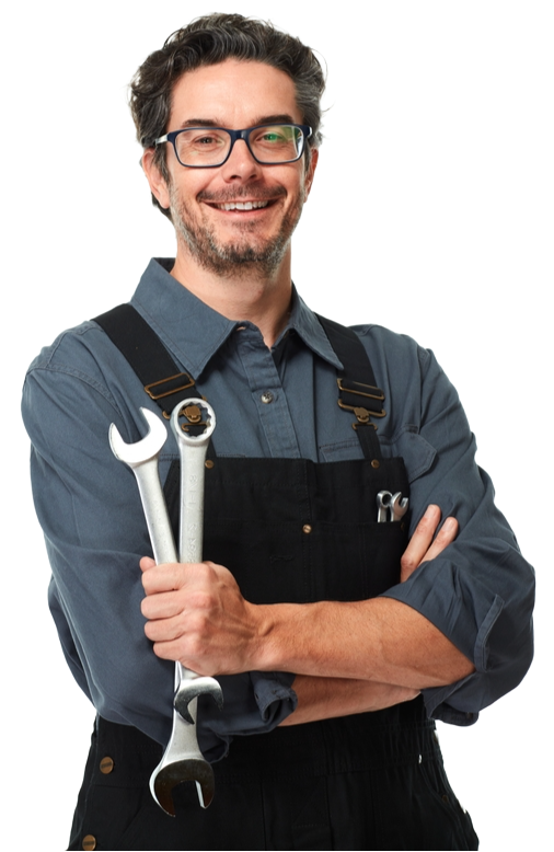 A man in overalls is holding two wrenches and smiling