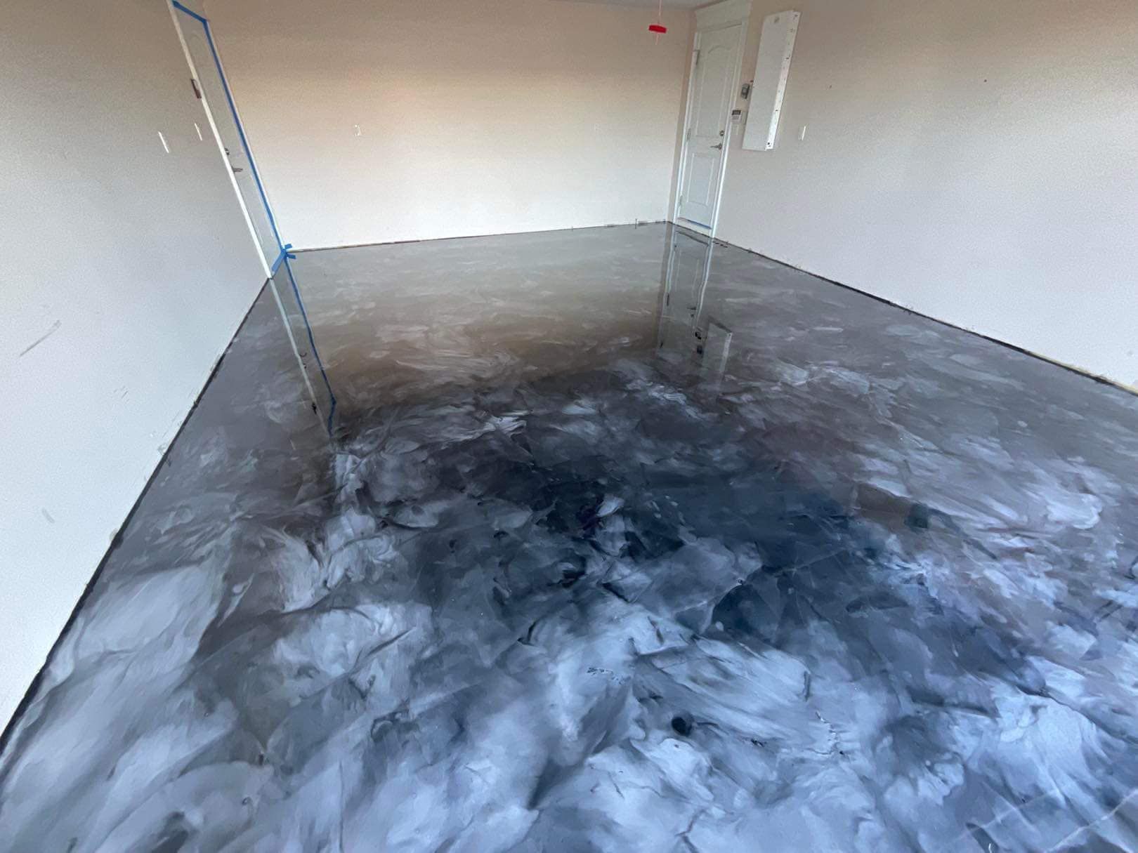 Metallic epoxy garage floor in shades of gray and silver.