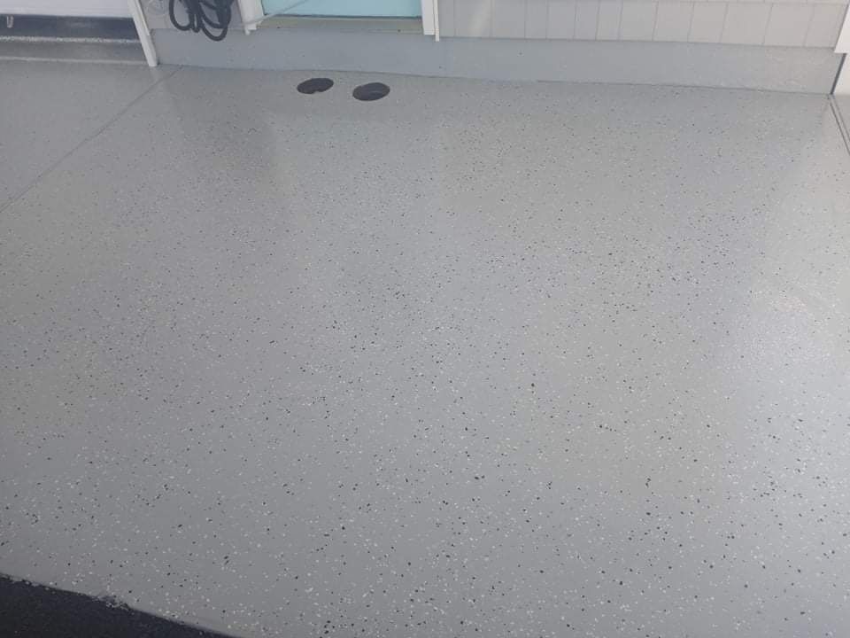 Gray epoxy garage floor with small flecks.