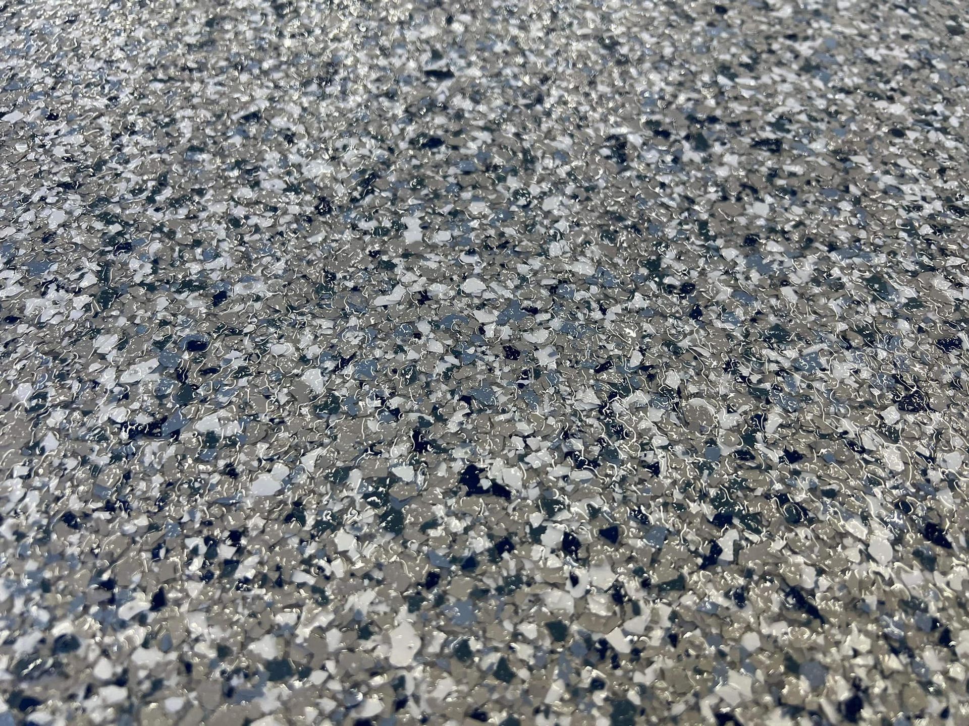 Gray and white speckled epoxy floor.